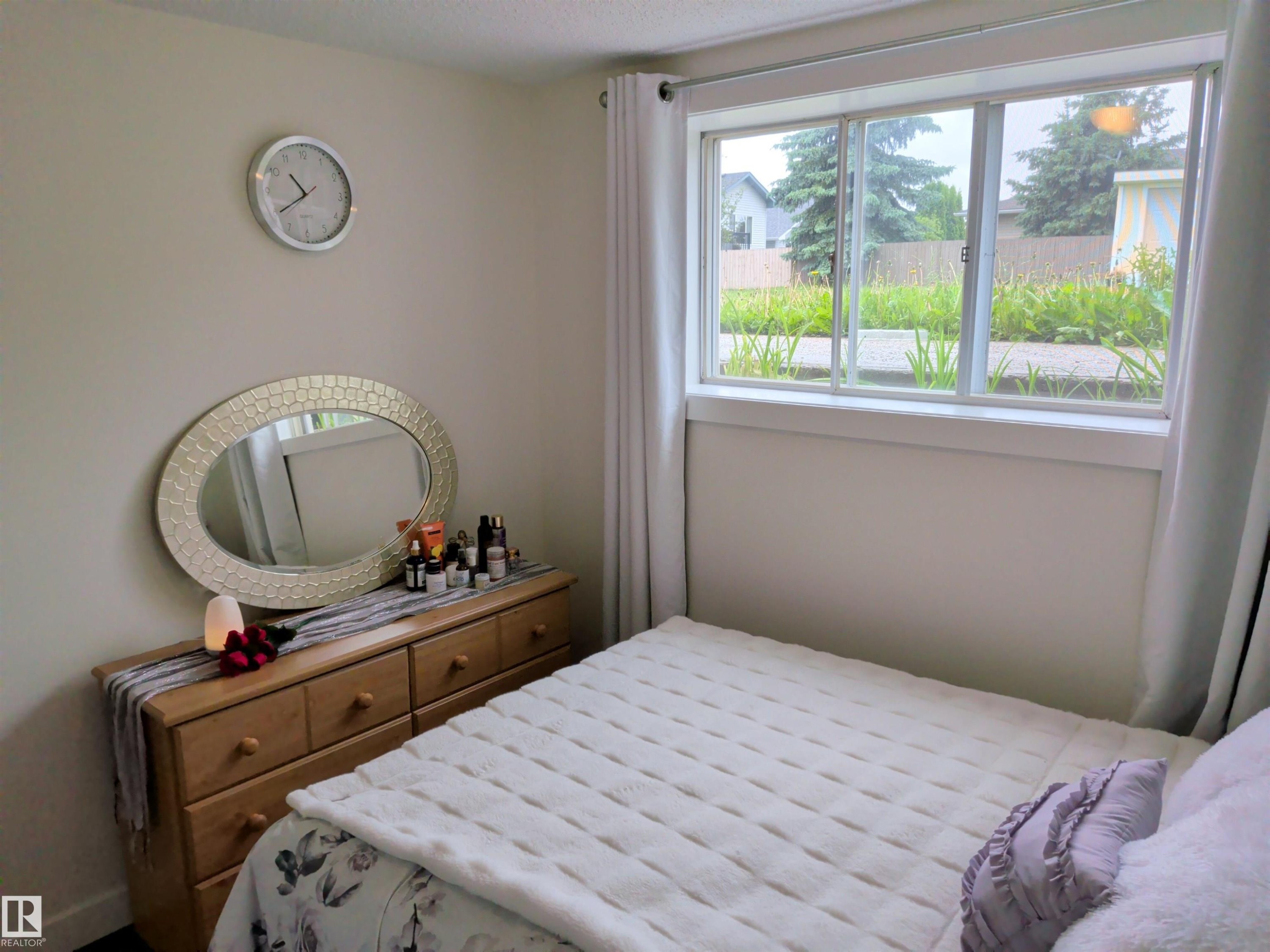 Room featuring a large window, light-colored walls, and a built-in window sill - 31 Brown Street, Stony Plain, AB