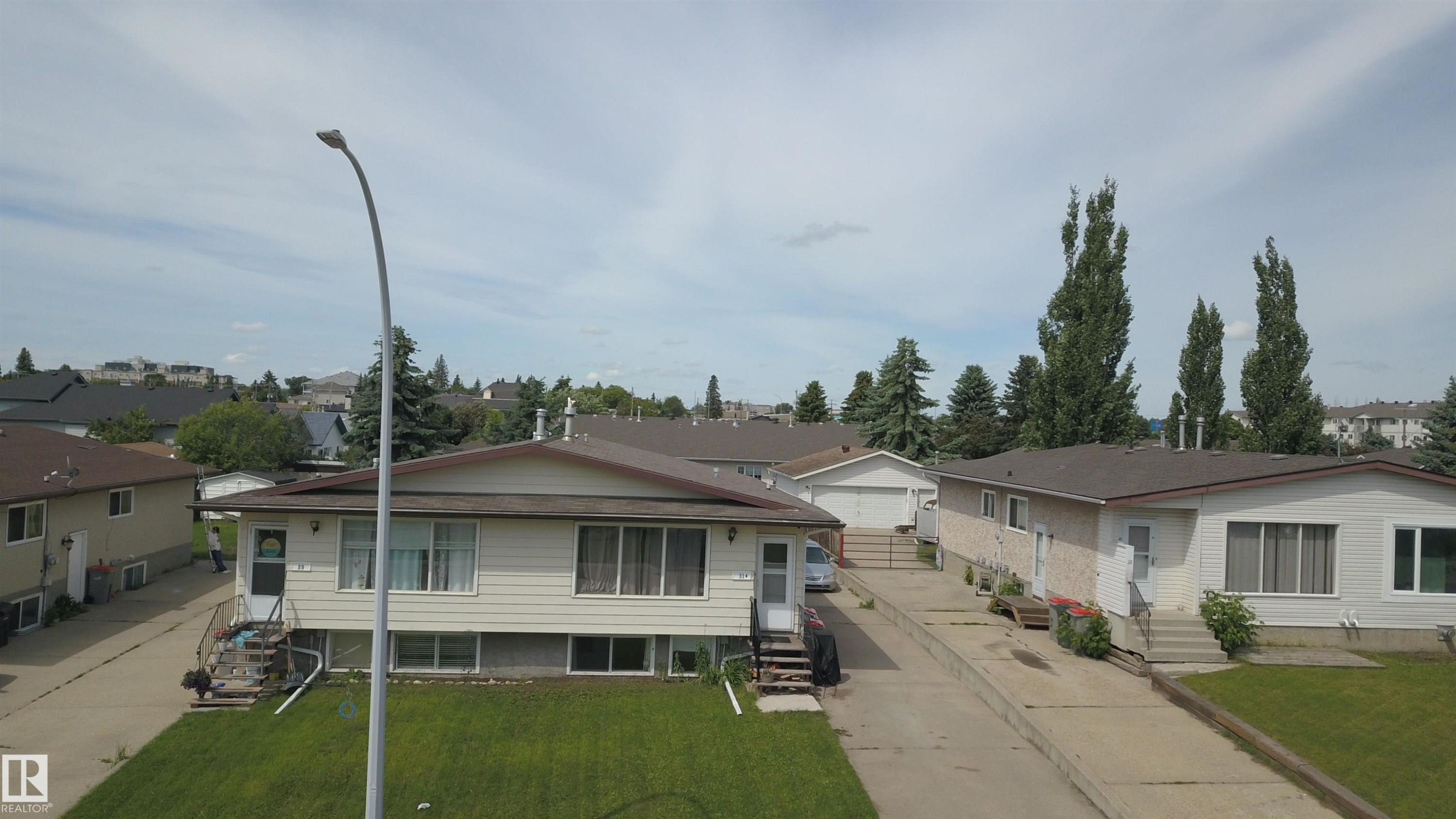 Single-story residence featuring light-colored siding and a brown shingle roof - 31 Brown Street, Stony Plain, AB