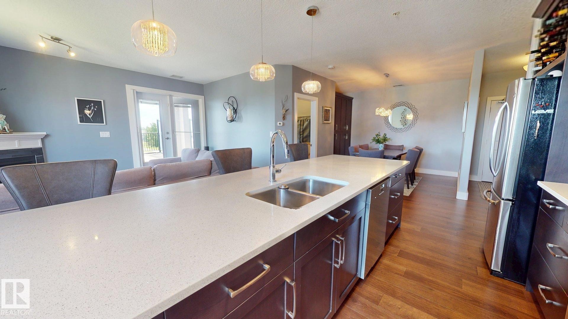 #355 6079 Maynard Wy Nw, Edmonton, AB - Indoor Photo Showing Kitchen With Double Sink