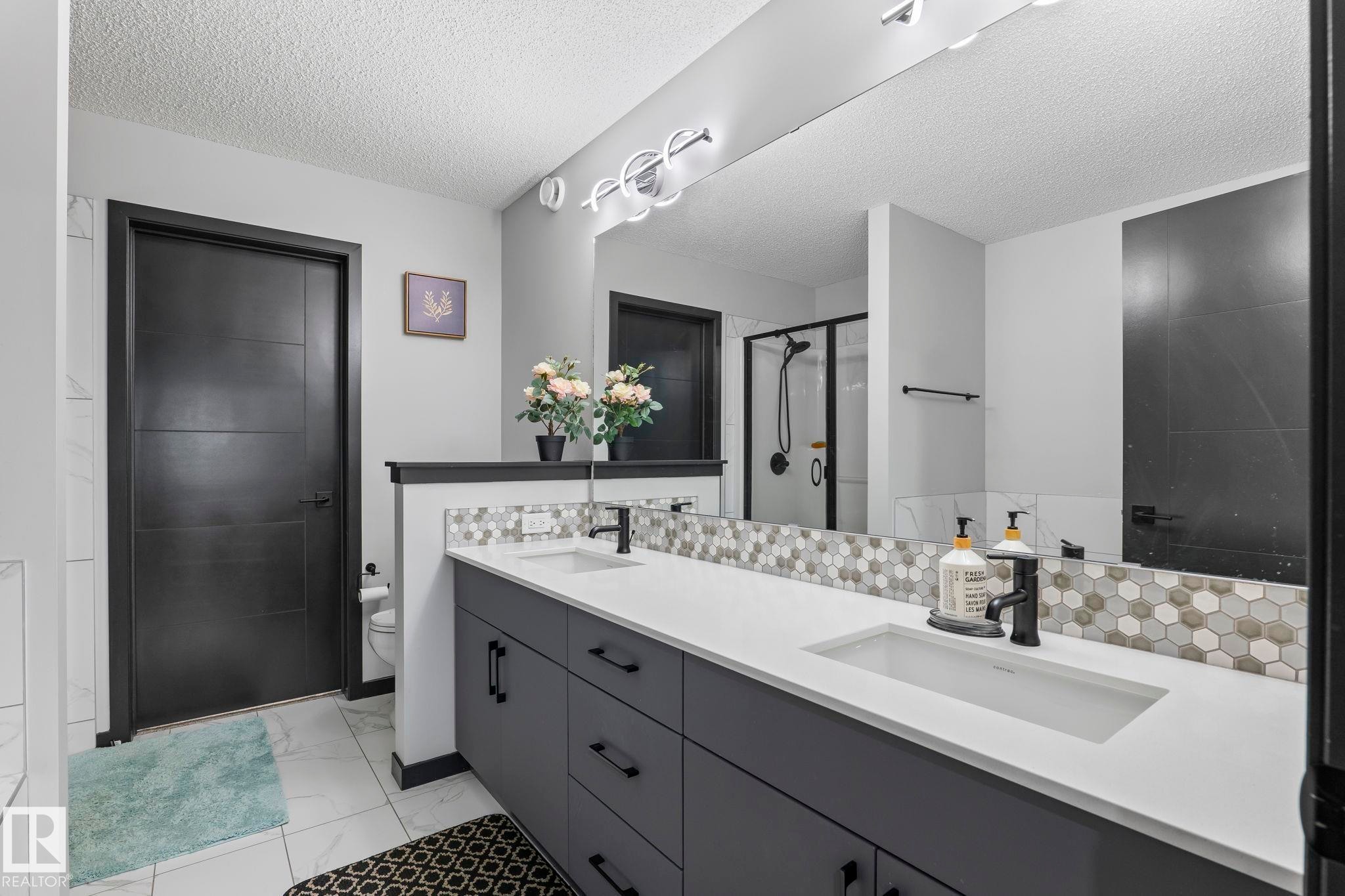 Dual vanity with integrated sinks and white countertops - 5110 23A Ave Sw, Edmonton, AB