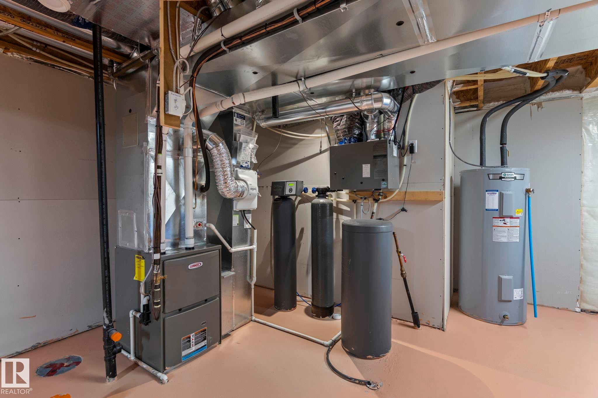 Mechanical room featuring a furnace, water heater, and water filtration system - 5110 23A Ave Sw, Edmonton, AB