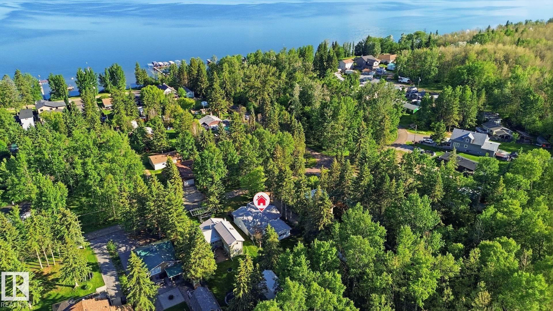 Aerial perspective showcasing a residential area amidst extensive mature tree coverage - 1410 47436 Range Rd. 15, Rural Leduc County, AB