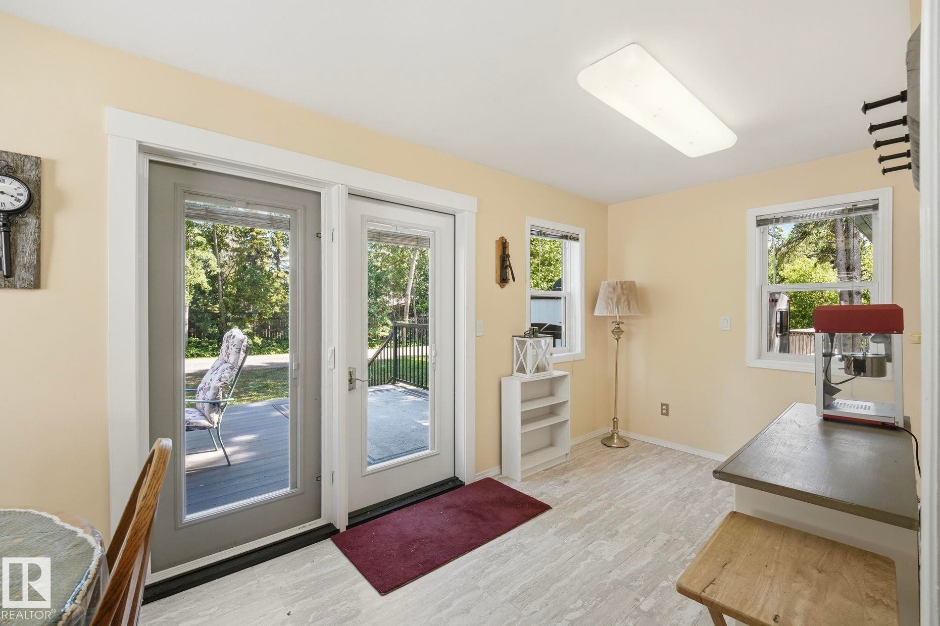 Interior space featuring light-toned walls and wood-finish flooring - 1410 47436 Range Rd. 15, Rural Leduc County, AB