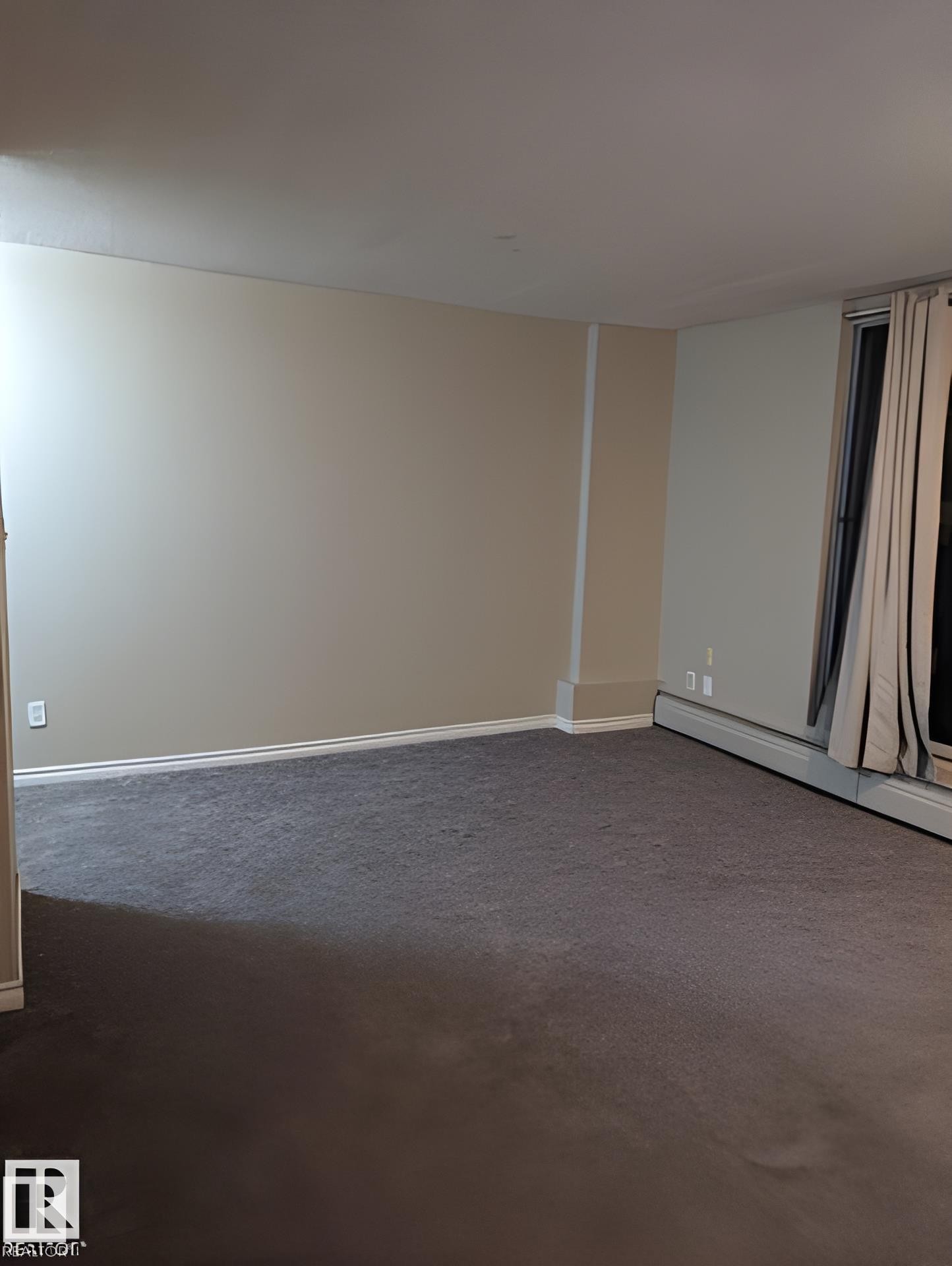 Spacious room with neutral wall tones, grey carpeting, and white baseboards - 611 12831 66 Street, Edmonton, AB
