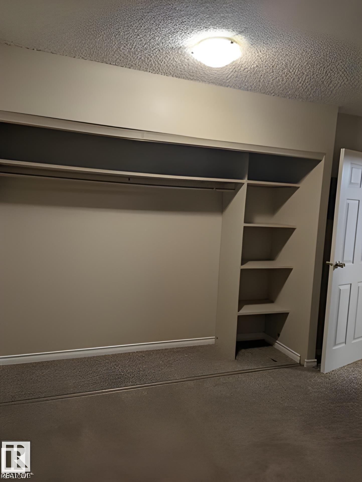 Built-in closet system featuring hanging rods and integrated shelving - 611 12831 66 Street, Edmonton, AB