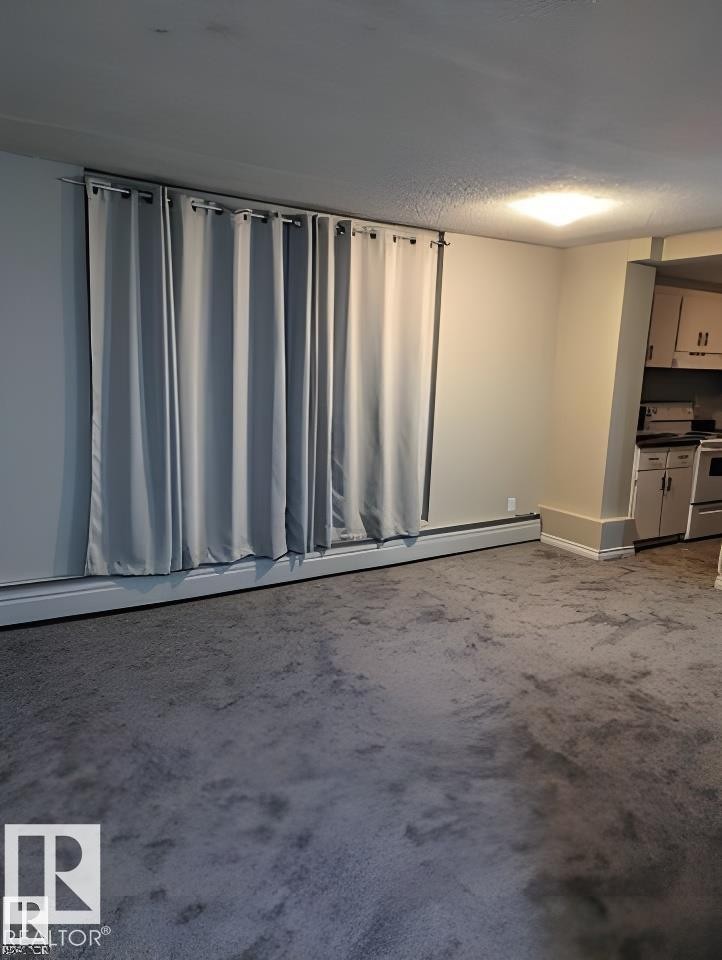 Open concept living area featuring neutral wall paint and gray carpeting - 611 12831 66 Street, Edmonton, AB