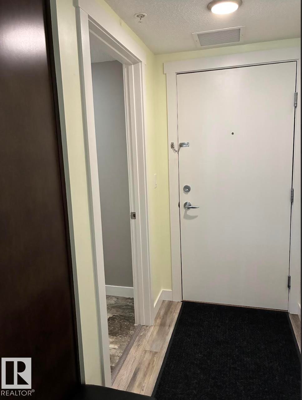 Entryway featuring light wood-finish flooring - #210 3670 139 Av Nw, Edmonton, AB - Indoor Photo Showing Other Room
