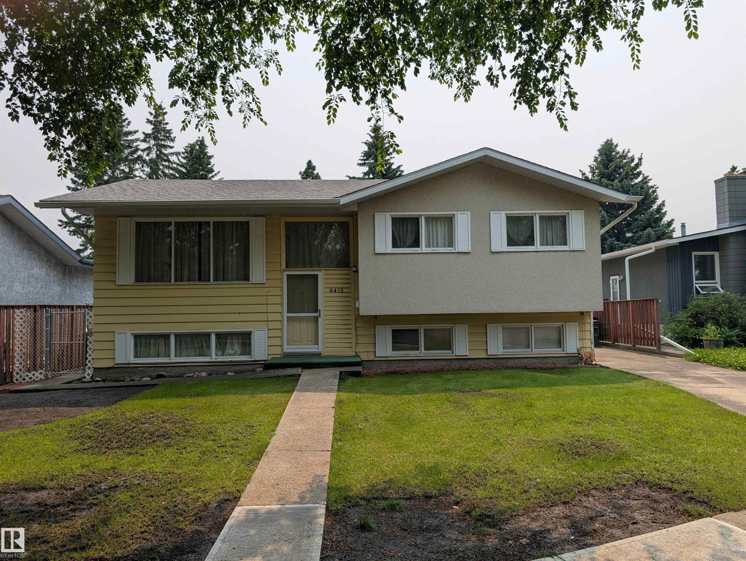Split-level residence featuring a partial stucco and horizontal siding facade - 6415 147 Avenue, Edmonton, AB