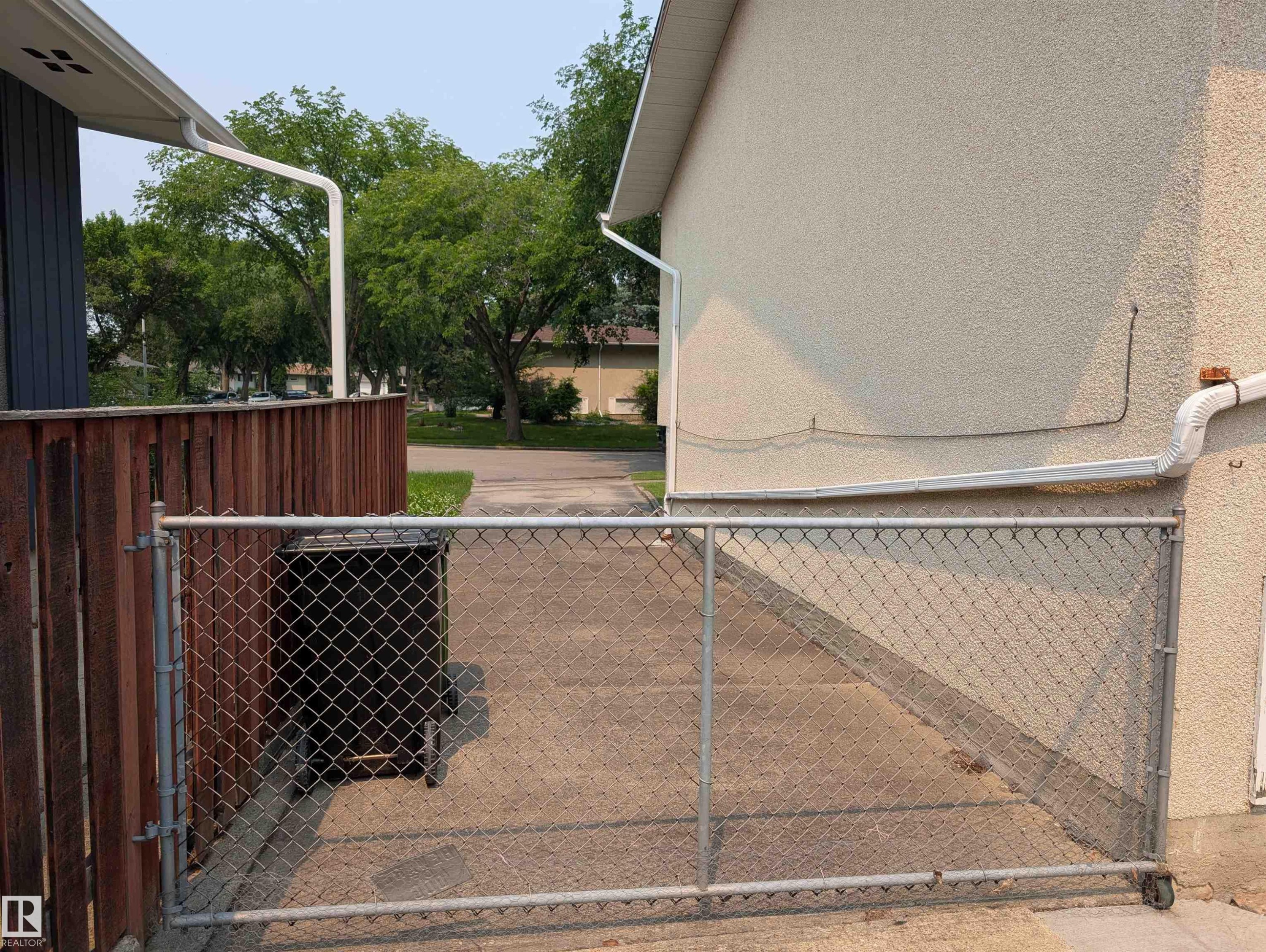 Concrete driveway with chain link gate - 6415 147 Avenue, Edmonton, AB