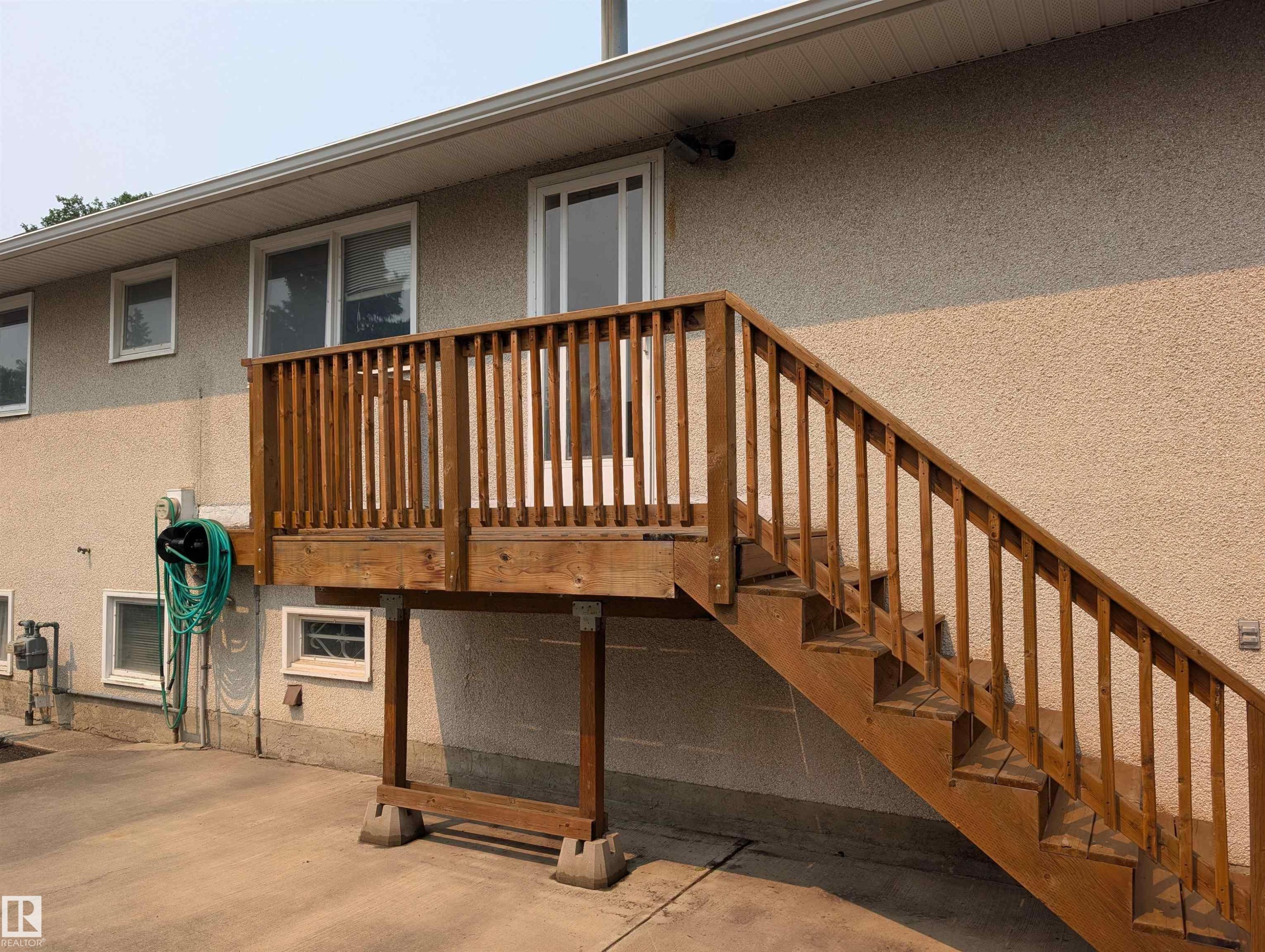 Exterior wood-finish deck with full balustrade and staircase - 6415 147 Avenue, Edmonton, AB