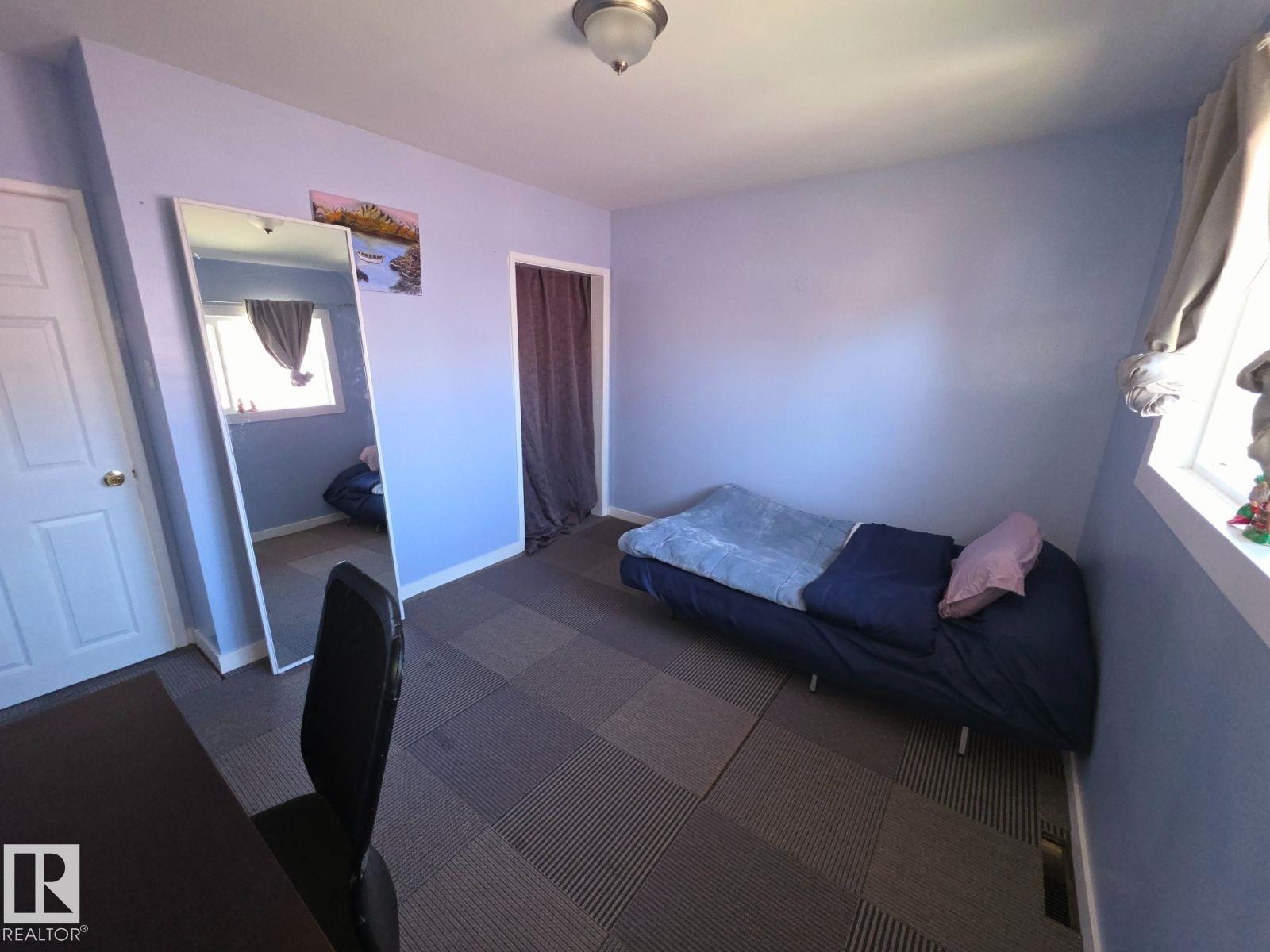 Light blue painted walls complement the textured flooring - 10404 116 Avenue, Edmonton, AB