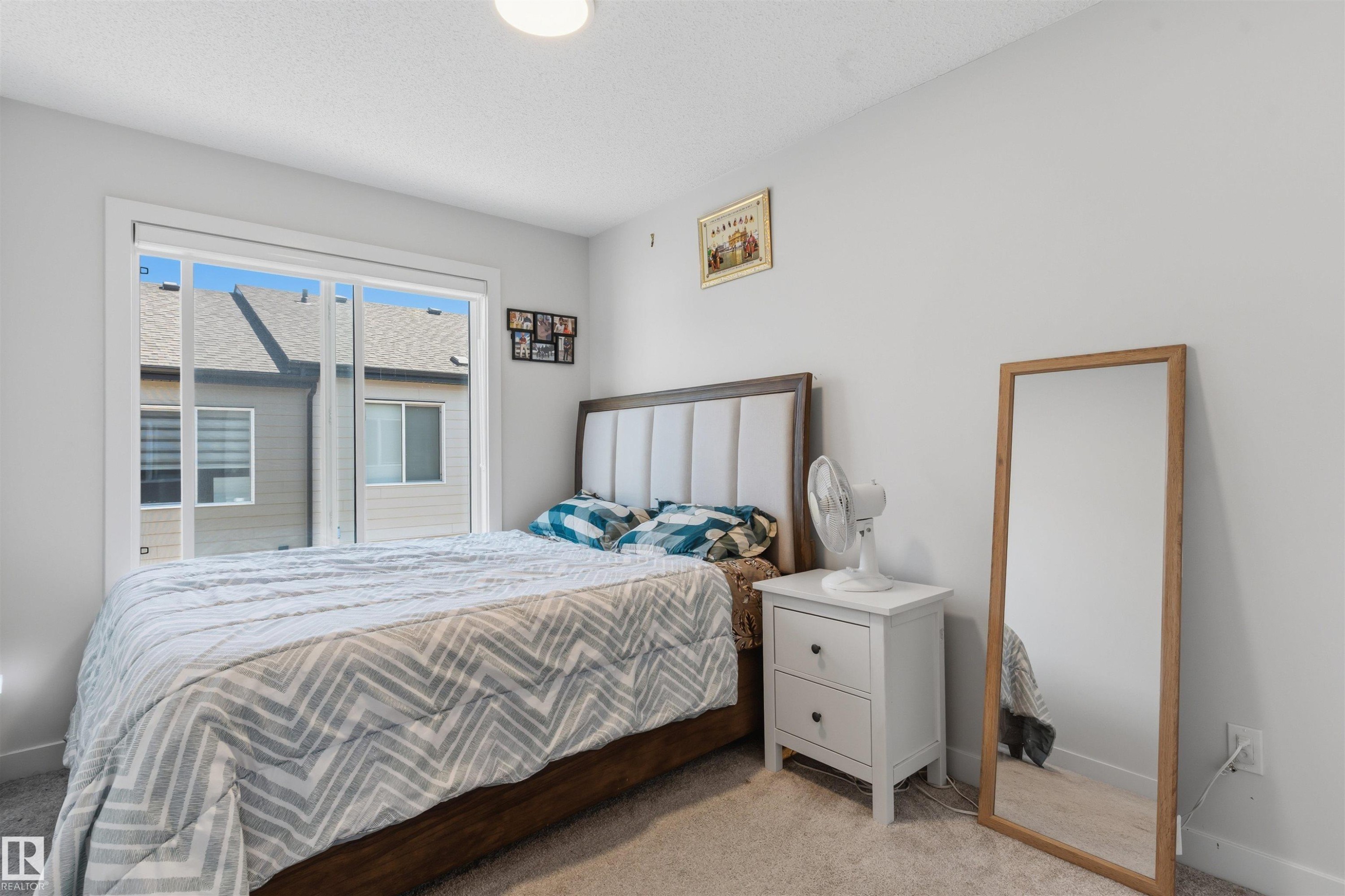 Carpeted room with a large window - 170 804 Welsh Drive, Edmonton, AB