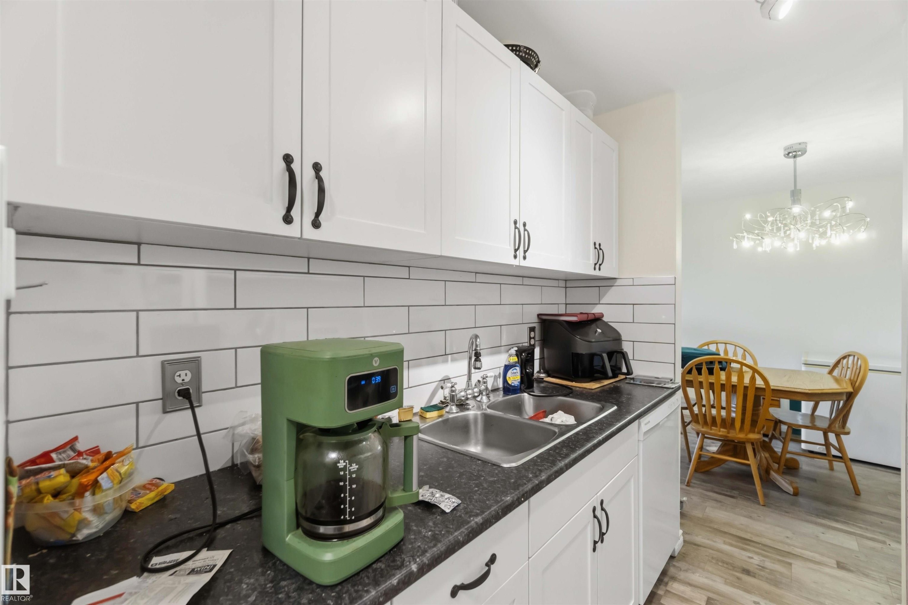 White shaker-style cabinetry with matte black hardware - 204 4601 131 Avenue, Edmonton, AB