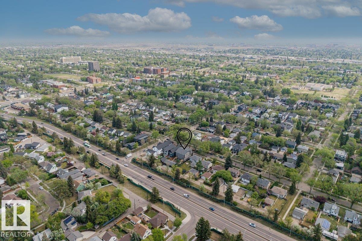 Aerial perspective highlighting a residential area with varied architectural styles and mature tree cover - 10932 132 Street, Edmonton, AB - Outdoor With View