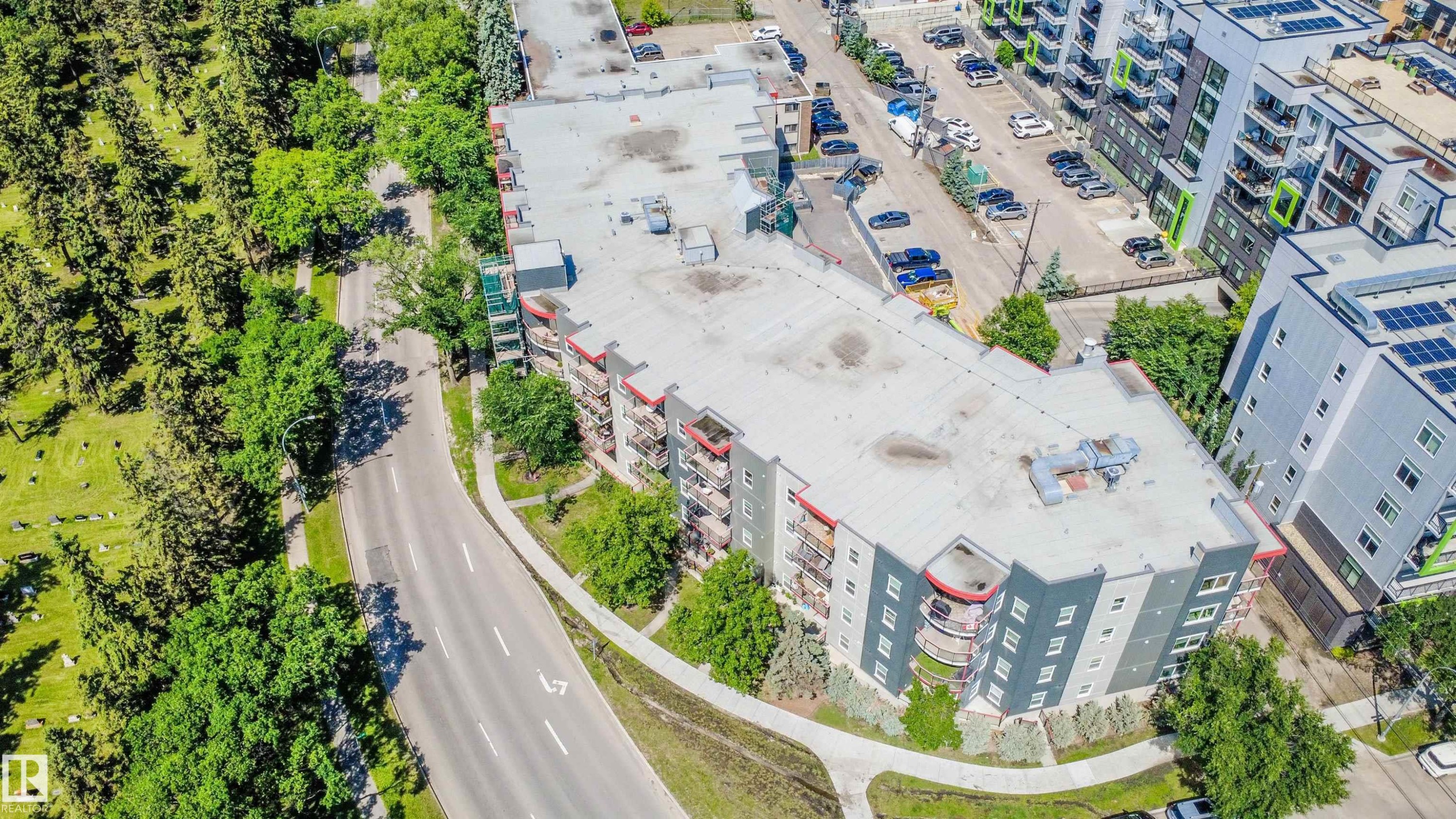 Multi-story building with a flat roof and a contemporary exterior featuring balconies - #209 10611 117 St Nw, Edmonton, AB