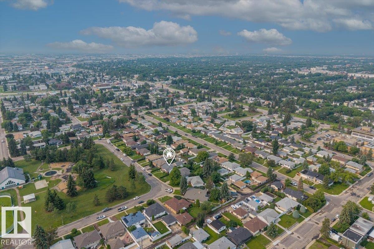 Residential property situated on a corner lot, surrounded by mature trees and paved streets - 8736 72 Street Nw, Edmonton, AB - Outdoor With View