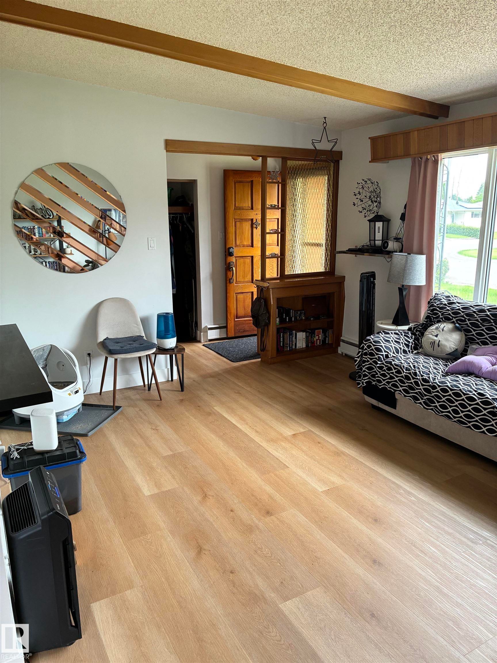 Light wood-finish flooring extending throughout the space - 8736 72 Street Nw, Edmonton, AB - Indoor