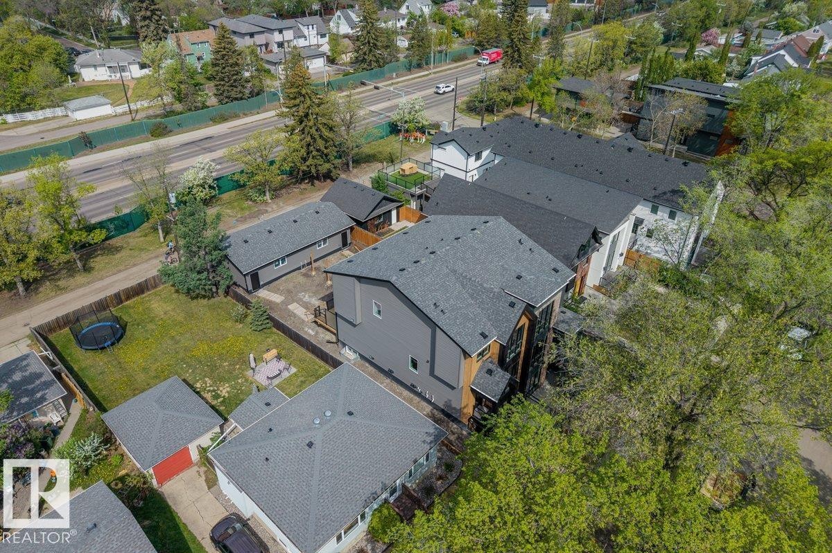 Modern residential property featuring a multi-level design and dark shingled roof - 10934 132 Street, Edmonton, AB - Outdoor With View