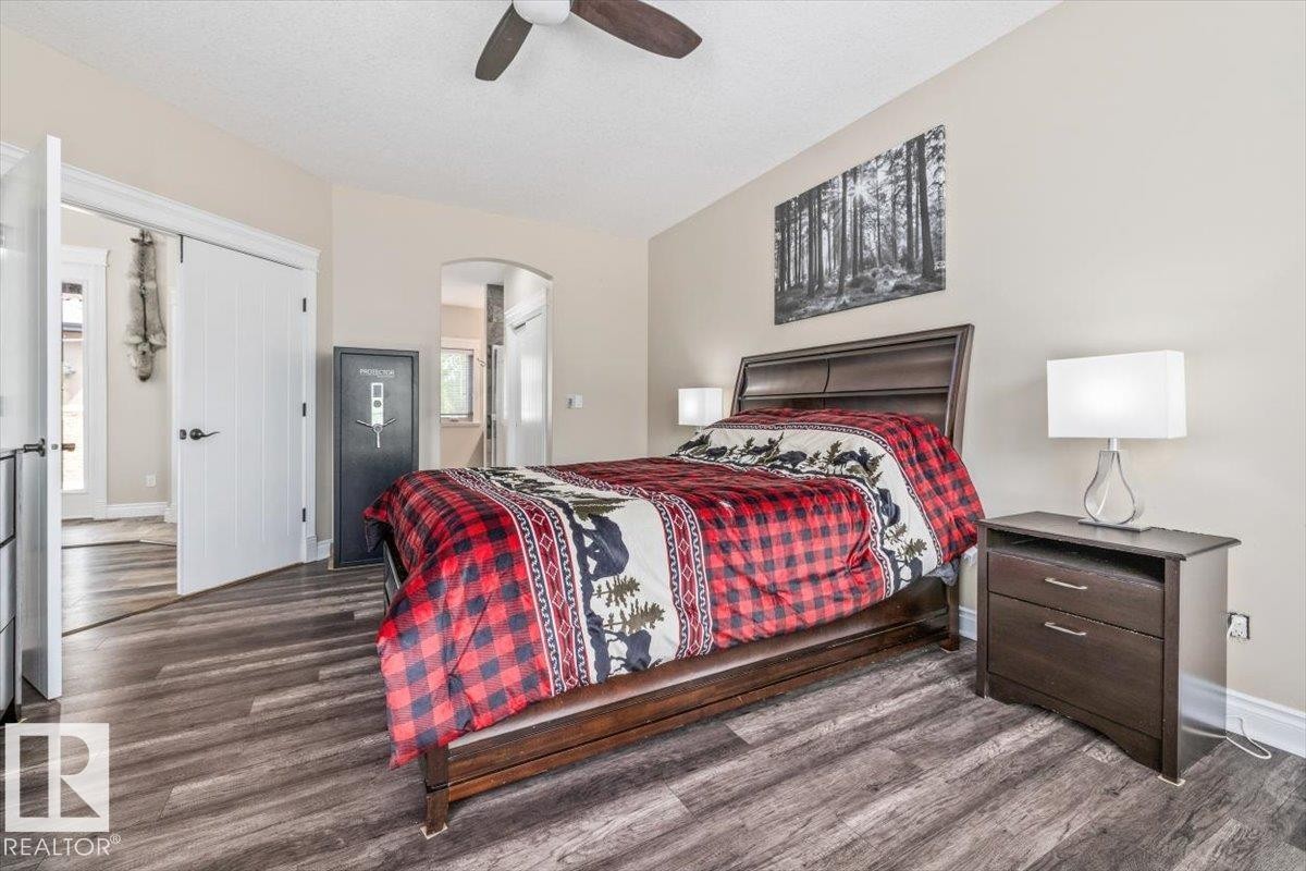 Bedroom featuring wood-finish flooring, neutral wall tones, and a ceiling fan - #6 2406 Twp Road 540, Rural Lac Ste. Anne County, AB - Indoor Photo Showing Bedroom
