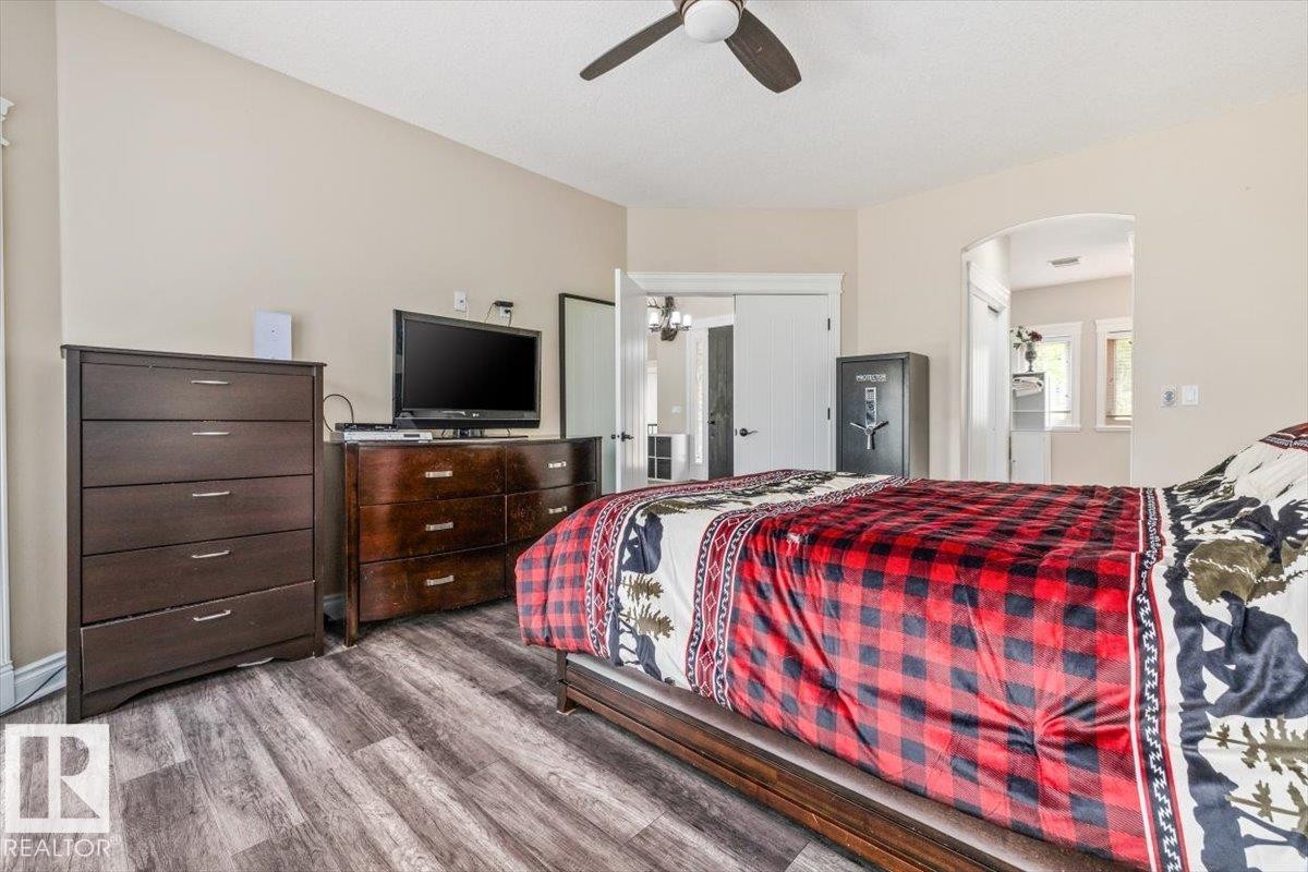 Bedroom featuring wood-finish flooring, a ceiling fan, and light-toned walls - #6 2406 Twp Road 540, Rural Lac Ste. Anne County, AB - Indoor Photo Showing Bedroom