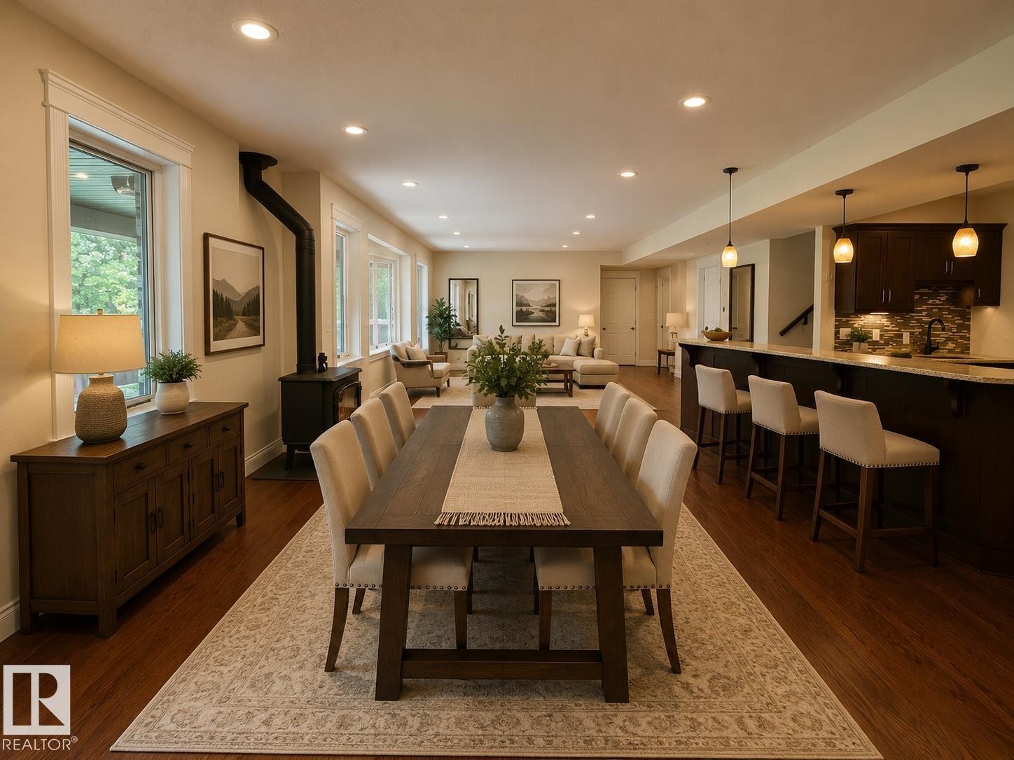Open-concept living space featuring wood-finish flooring, recessed lighting, and a prominent wood-burning stove - #6 2406 Twp Road 540, Rural Lac Ste. Anne County, AB - Indoor Photo Showing Dining Room