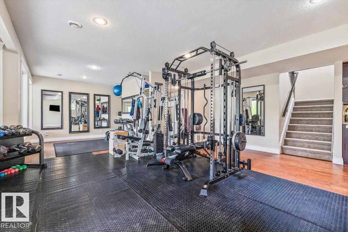 Recreational room with black rubber flooring, recessed lighting, and wall-mounted mirrors - #6 2406 Twp Road 540, Rural Lac Ste. Anne County, AB - Indoor Photo Showing Gym Room