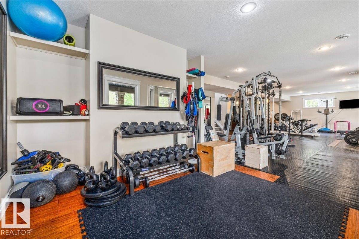 Dedicated fitness area featuring recessed lighting and a large framed mirror - #6 2406 Twp Road 540, Rural Lac Ste. Anne County, AB - Indoor Photo Showing Gym Room