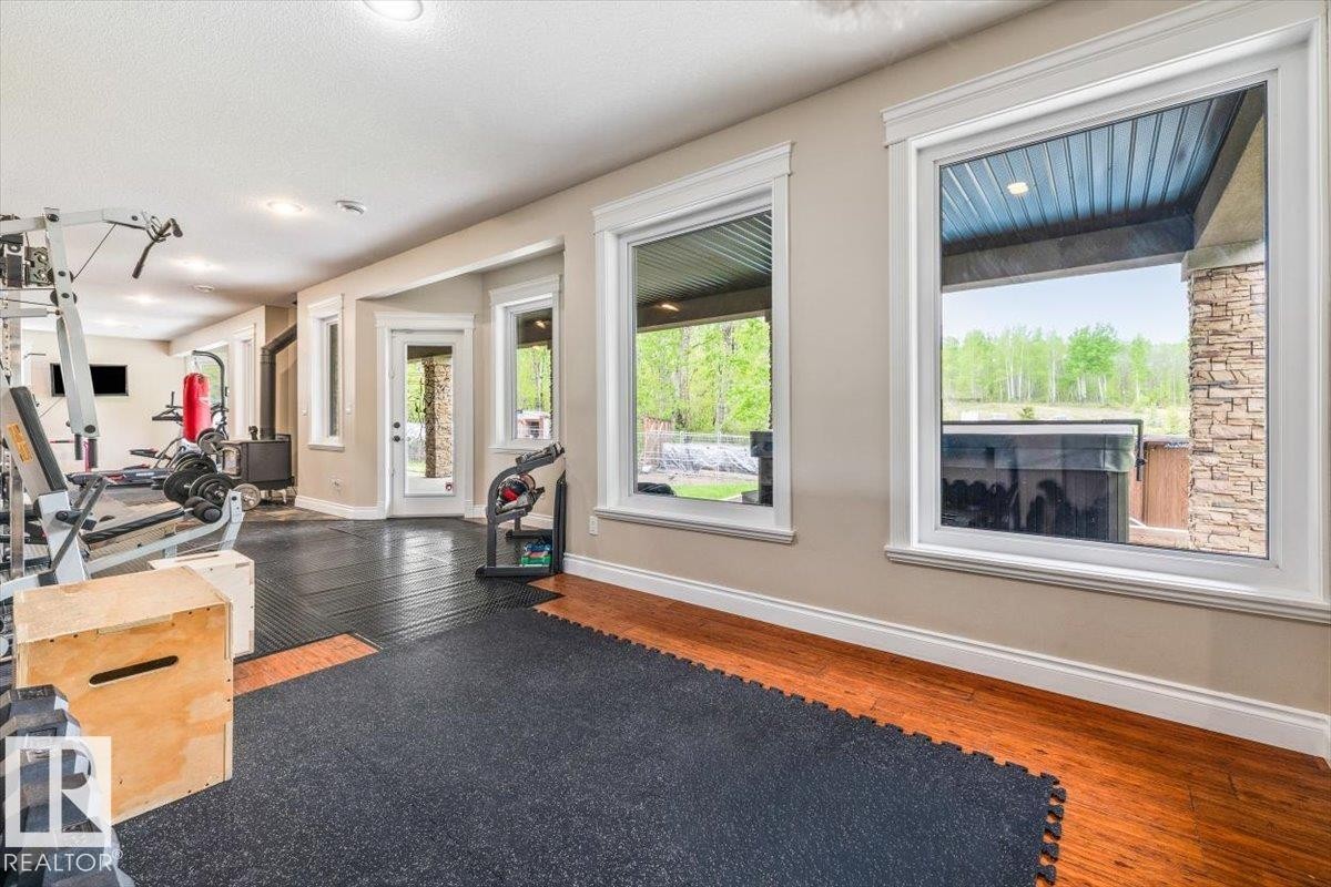 Dedicated interior space featuring large windows, a wood-finish floor, recessed lighting, and direct exterior access - #6 2406 Twp Road 540, Rural Lac Ste. Anne County, AB - Indoor Photo Showing Gym Room