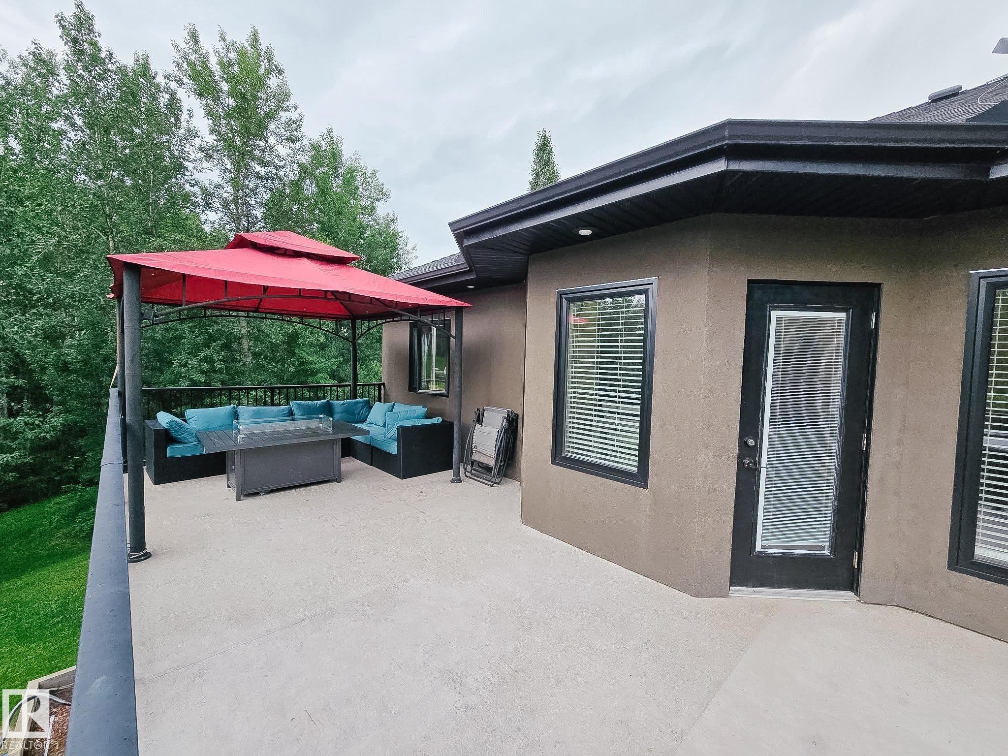 Spacious concrete balcony featuring a black metal railing and direct exterior access - #6 2406 Twp Road 540, Rural Lac Ste. Anne County, AB - Outdoor With Exterior