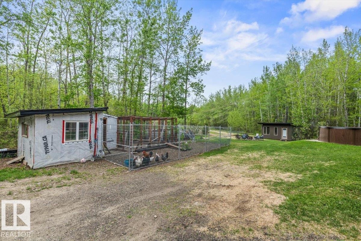Exterior structure featuring white house wrap siding, a white-framed window, and a flat black roofline - #6 2406 Twp Road 540, Rural Lac Ste. Anne County, AB - Outdoor