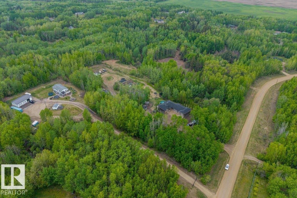 Expansive, treed acreage with multiple structures, including a primary residence with a dark roof, a secondary residence with a light roof, and a large outbuilding - #6 2406 Twp Road 540, Rural Lac Ste. Anne County, AB - Outdoor With View