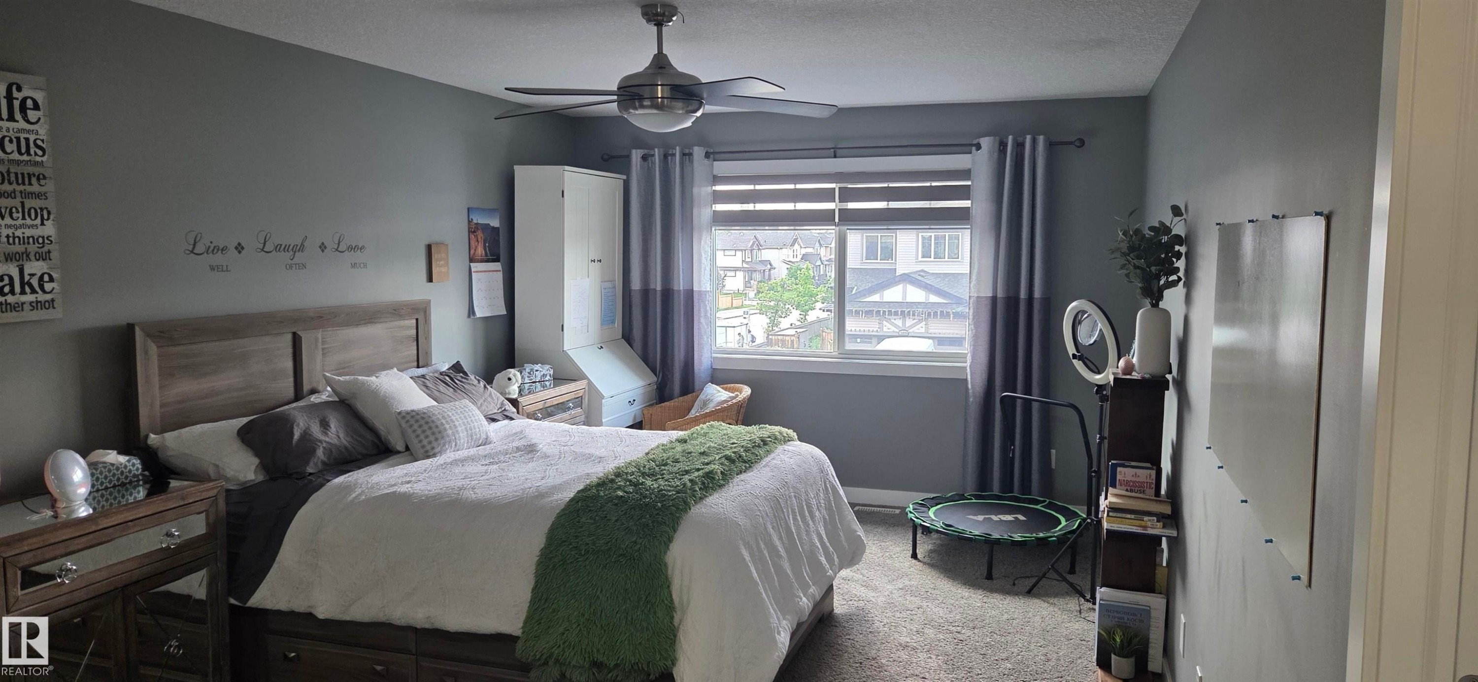 Spacious room featuring neutral grey walls and a large window with blinds - 16505 133 Street, Edmonton, AB