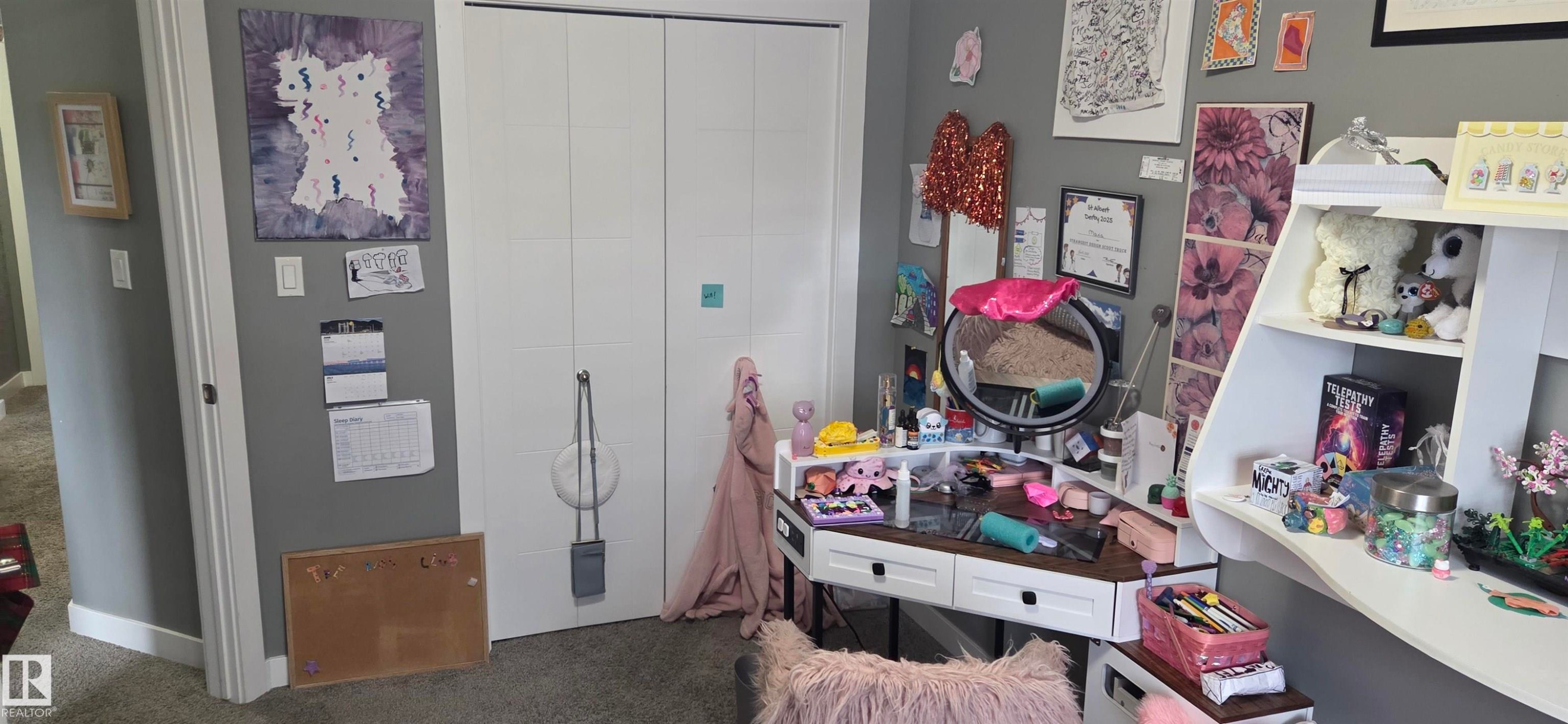Carpeted room featuring a double-door closet with white panels - 16505 133 Street, Edmonton, AB