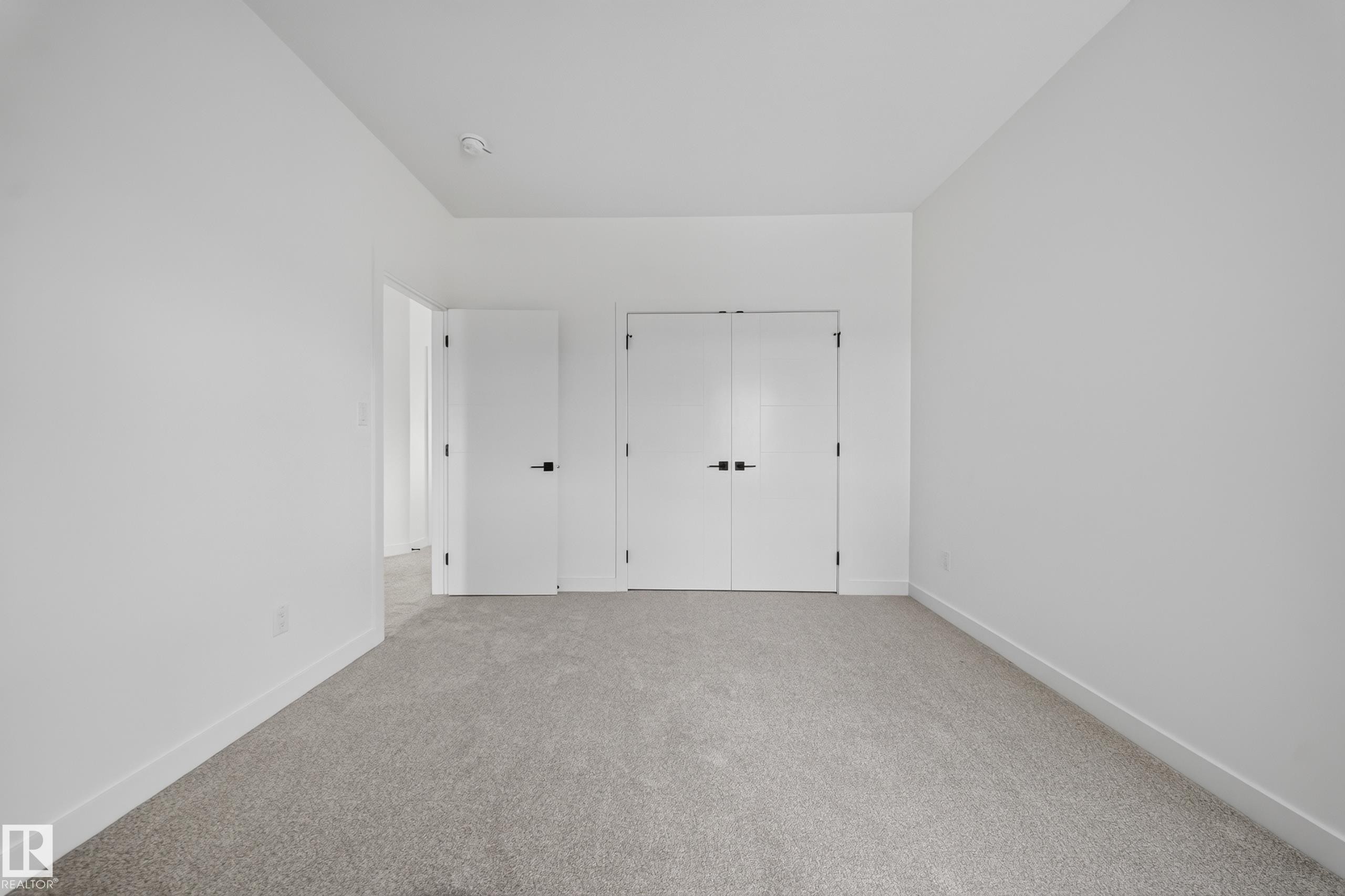 Carpeted room with a recessed ceiling light - 523 Ashgrove Circle, Leduc, AB
