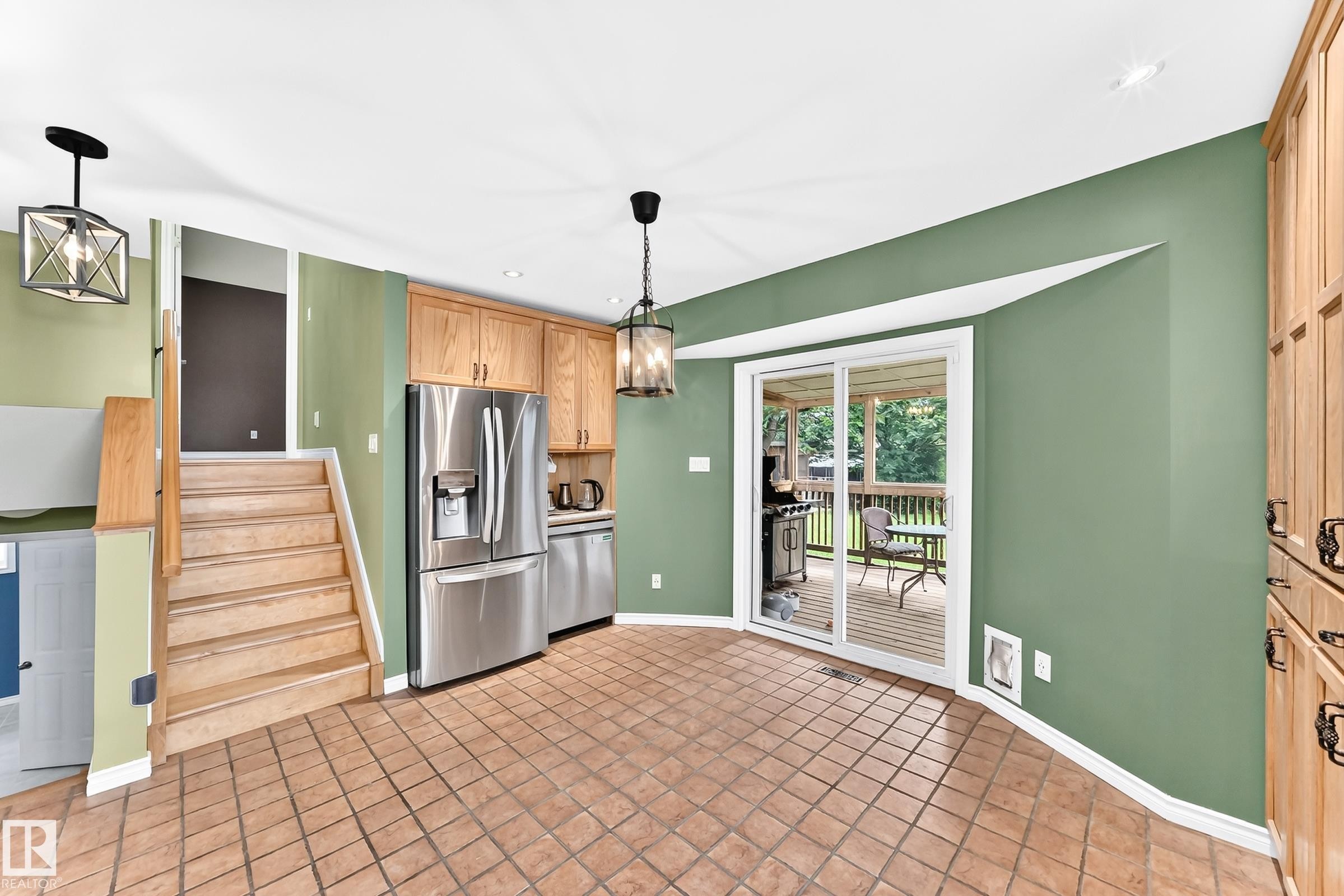 Kitchen area featuring terracotta tile flooring and light wood cabinetry - 1763 48A Street, Edmonton, AB