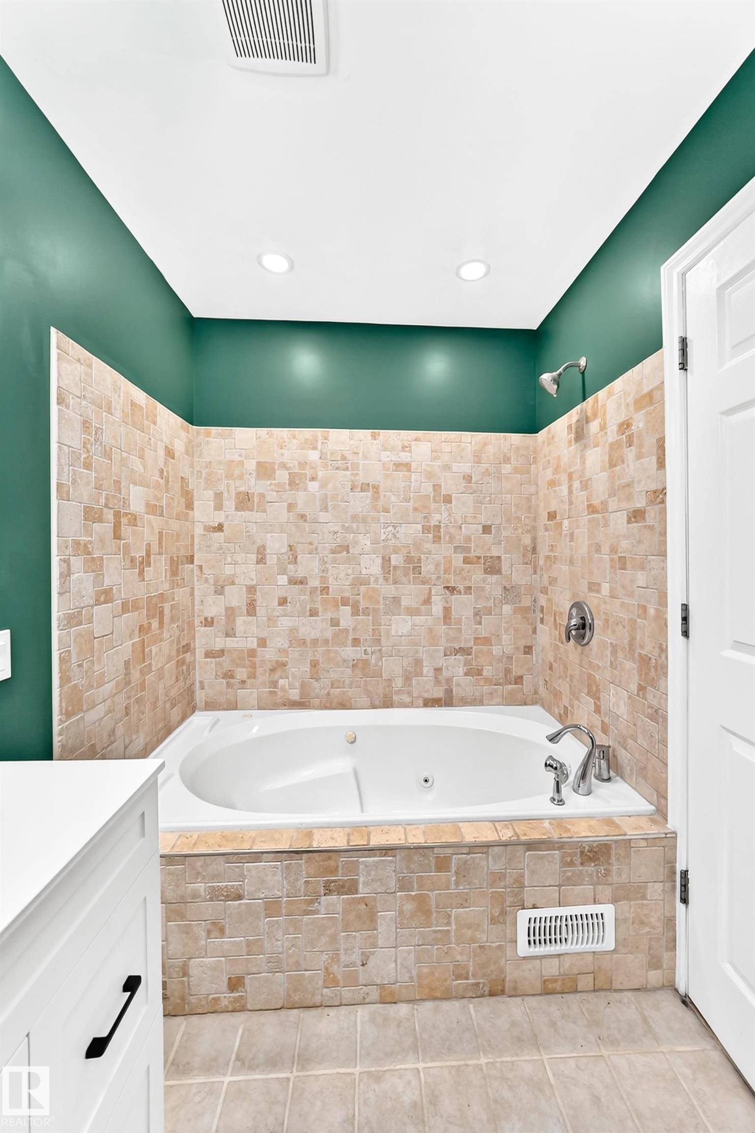 Built-in jetted tub with tile surround and wall tile extending to showerhead - 1763 48A Street, Edmonton, AB