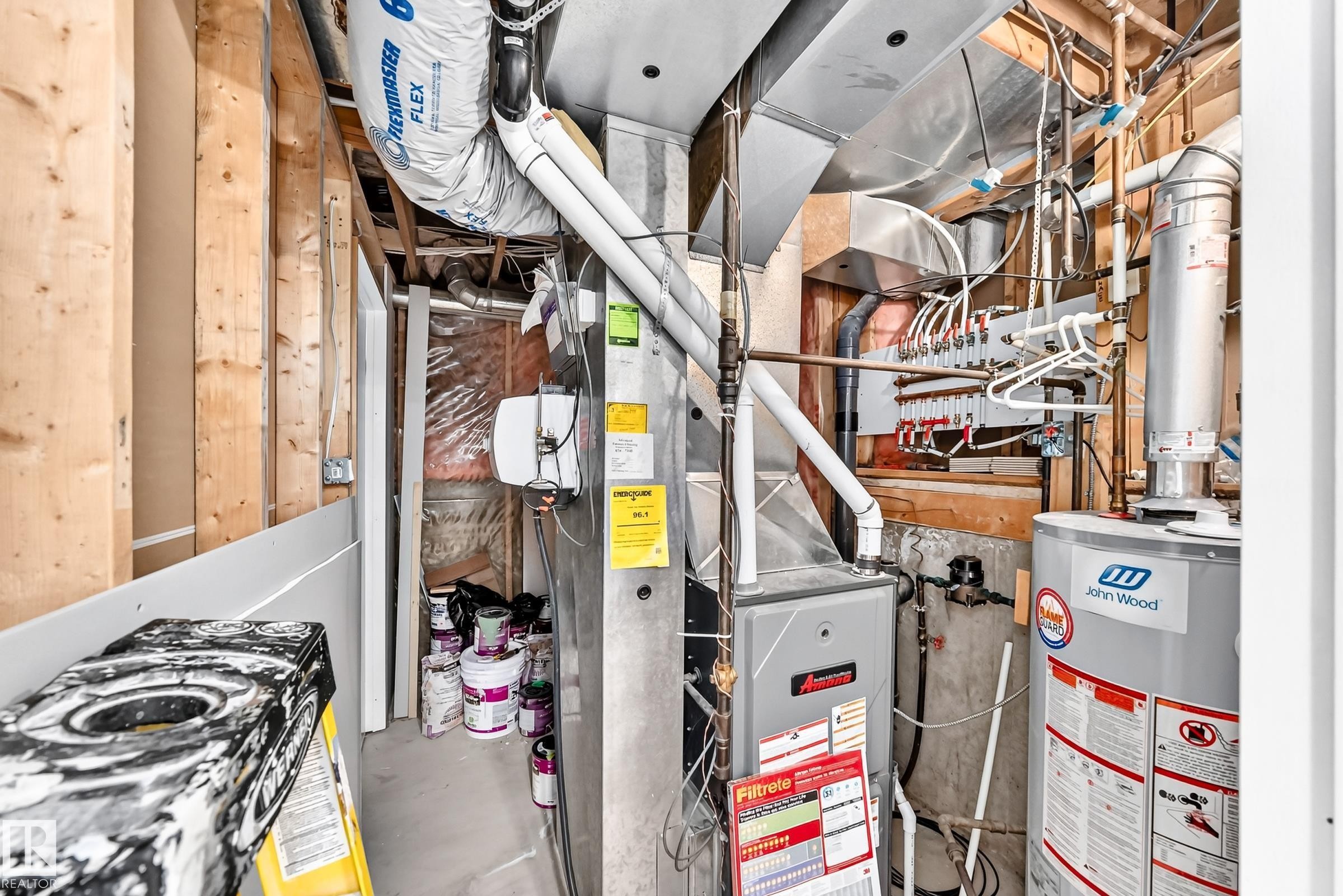 Mechanical room featuring a water heater, furnace, and exposed framing - 1763 48A Street, Edmonton, AB