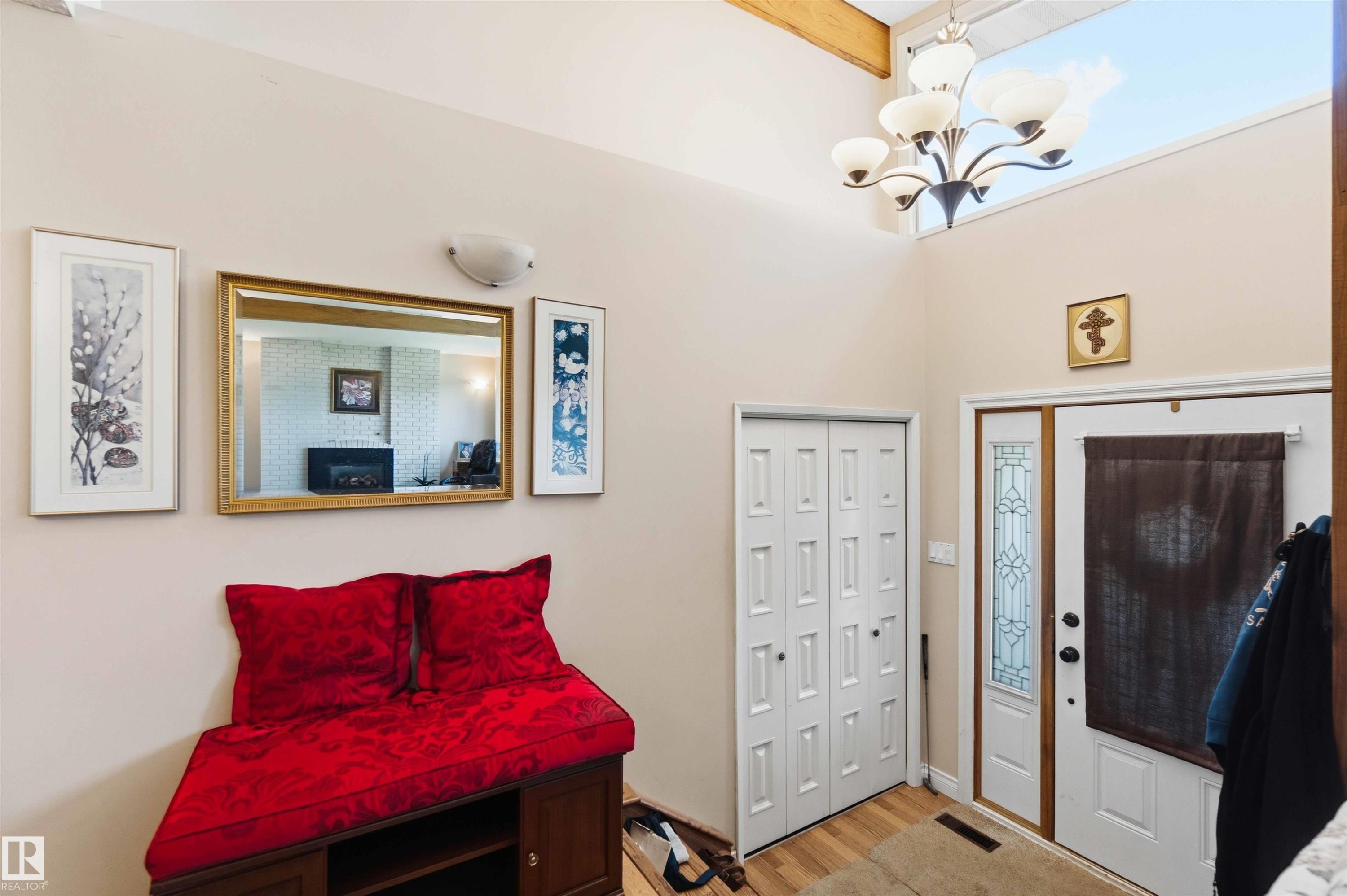Entryway featuring vaulted ceilings with exposed wood beams, a decorative chandelier, and a transom window - 13121 122 Street, Edmonton, AB
