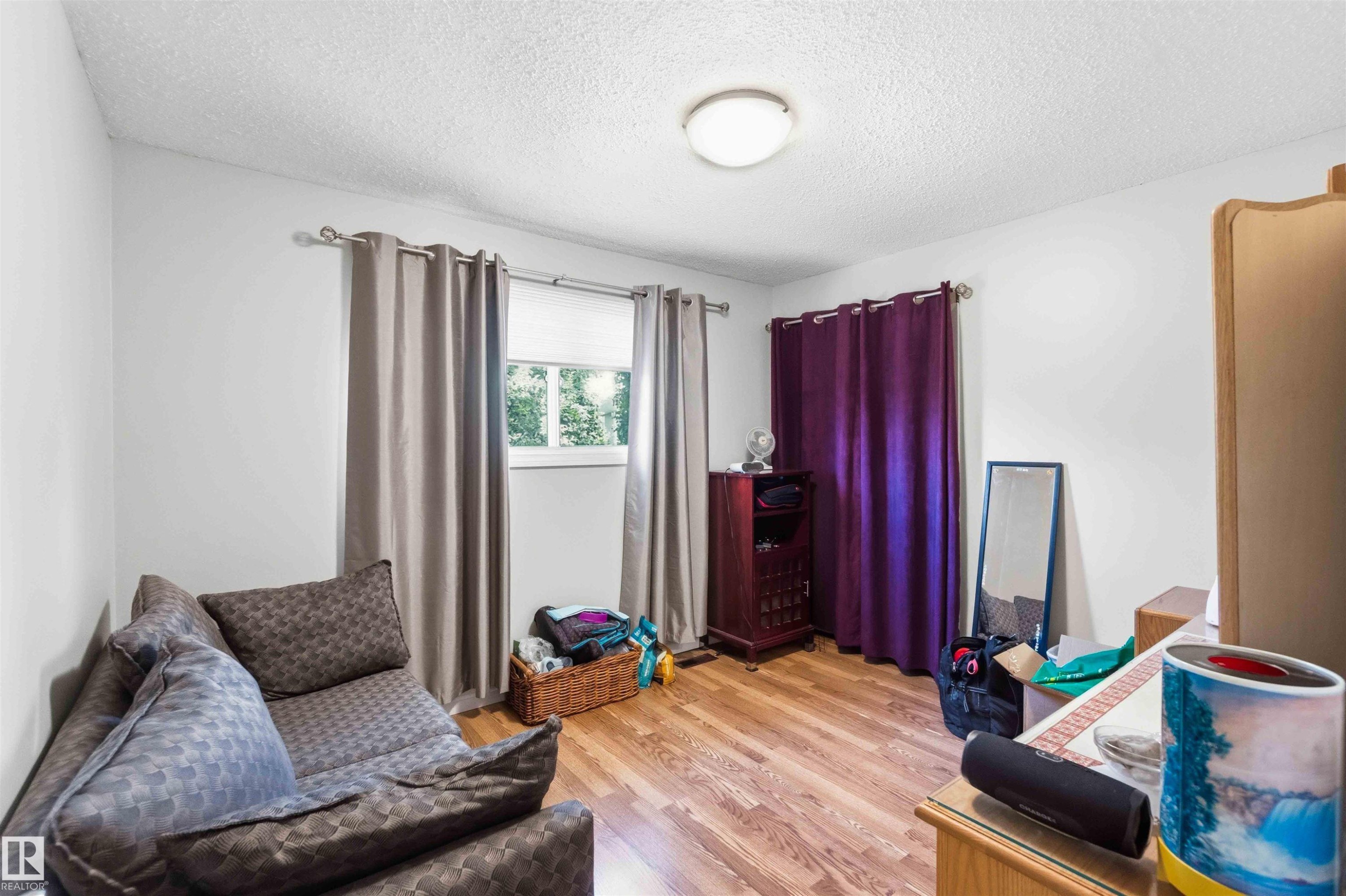Neutral white walls paired with wood-finish flooring - 13121 122 Street, Edmonton, AB