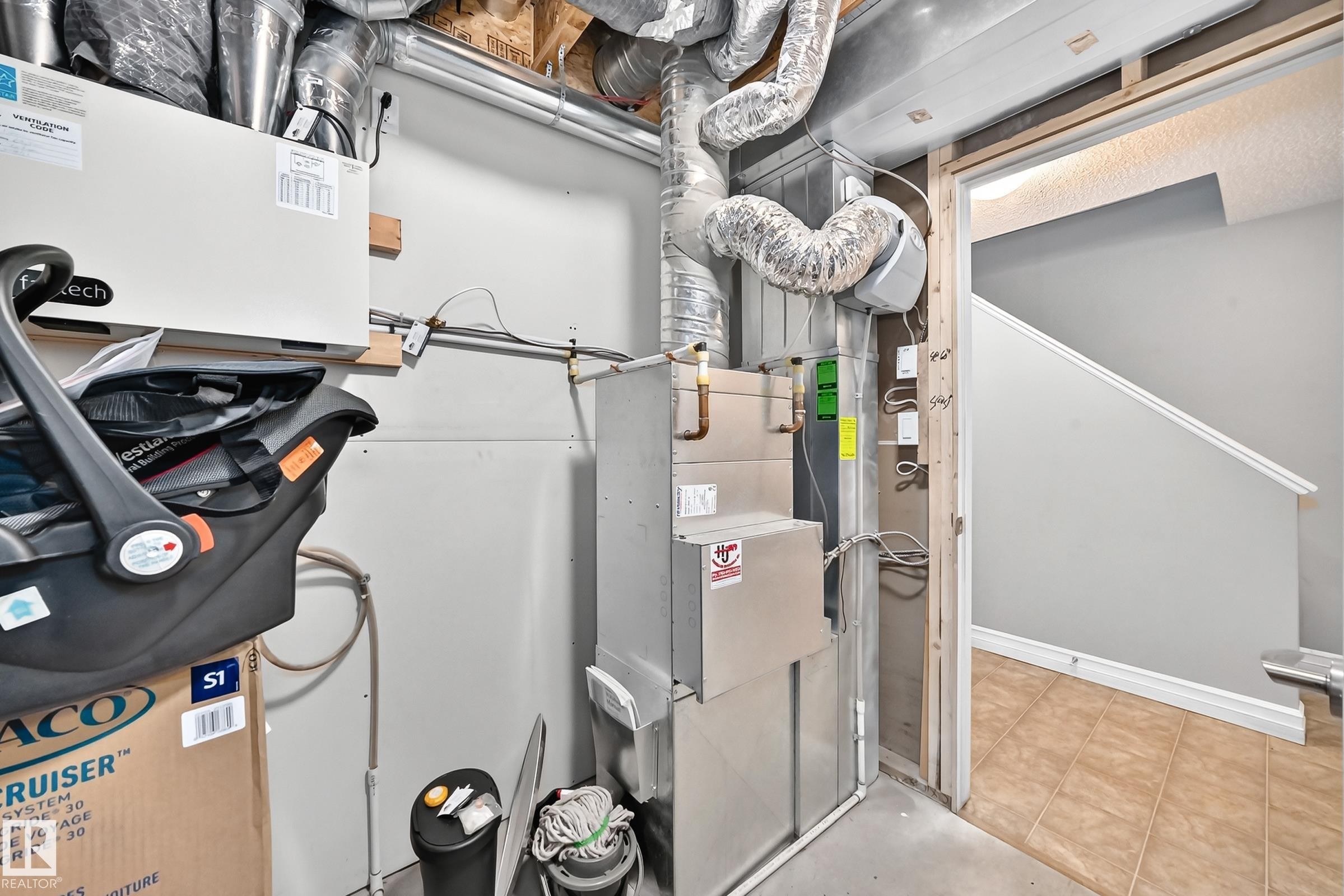 Utility space featuring a furnace, exposed ductwork, and an adjacent tiled floor area - 415 Clareview Rd Nw Nw, Edmonton, AB - Indoor Photo Showing Basement