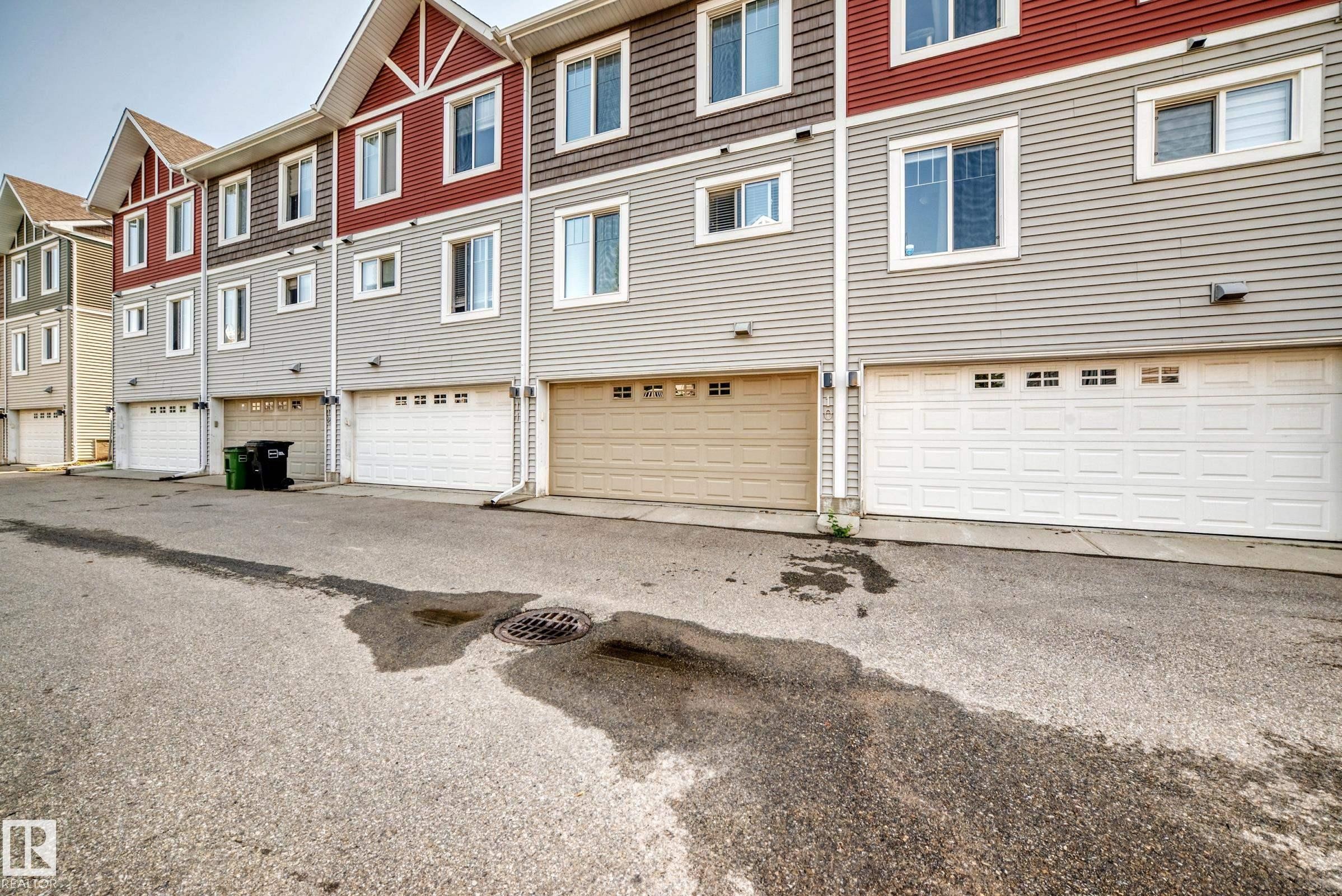 Rear exterior showcasing individual garage doors - 415 Clareview Rd Nw Nw, Edmonton, AB - Outdoor