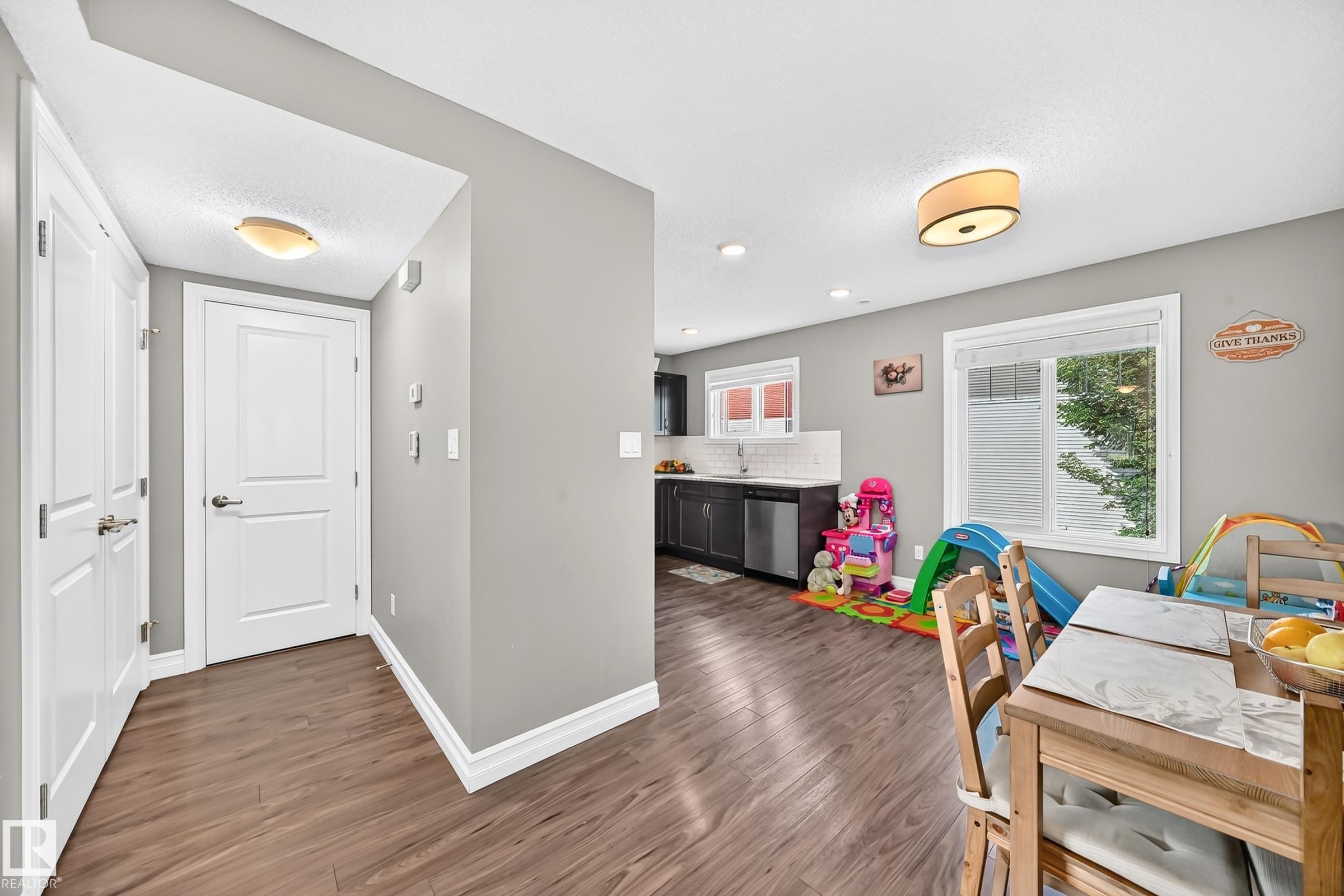 Entryway featuring wood-finish flooring, white paneled doors, and a flush mount ceiling light - 415 Clareview Rd Nw Nw, Edmonton, AB - Indoor Photo Showing Other Room