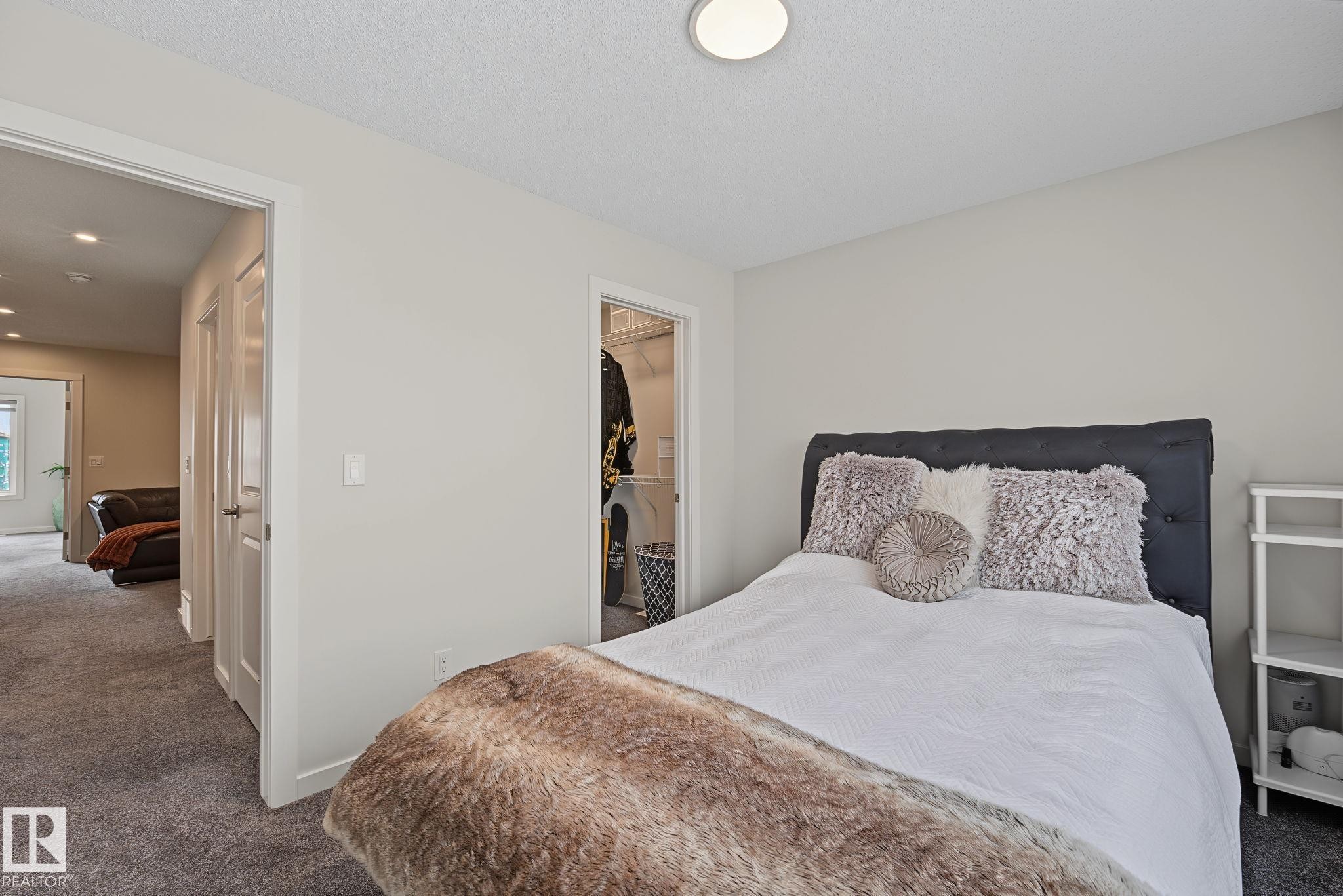 Bedroom with light grey wall paint and grey carpet flooring - 432 Roberts Crescent, Leduc, AB
