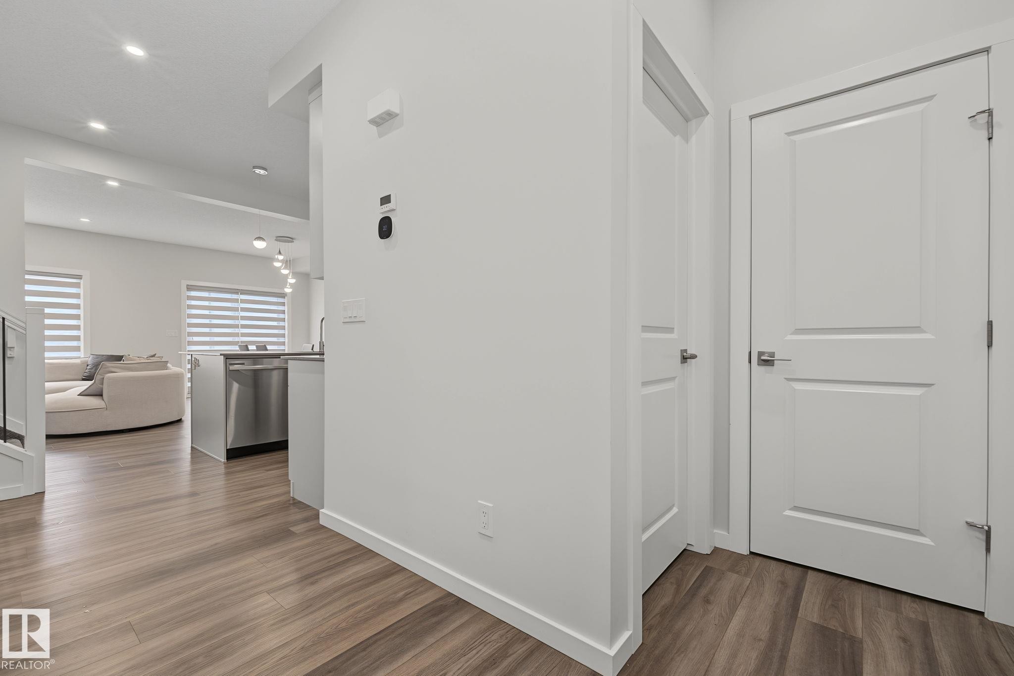 Contemporary interior with wood-finish flooring extending throughout - 432 Roberts Crescent, Leduc, AB