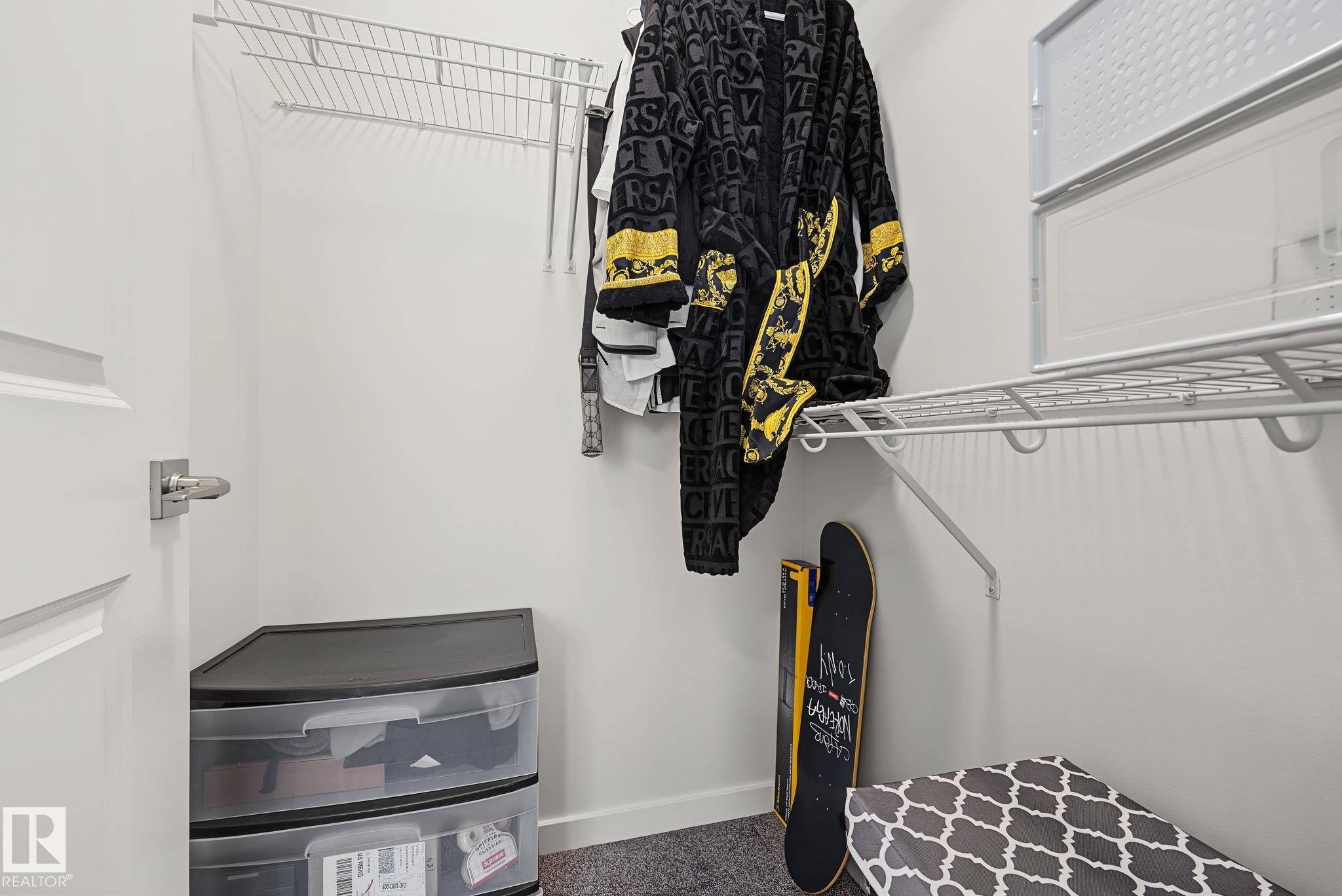 White-painted closet featuring durable wire shelving and a hanging rod for clothing organization - 432 Roberts Crescent, Leduc, AB