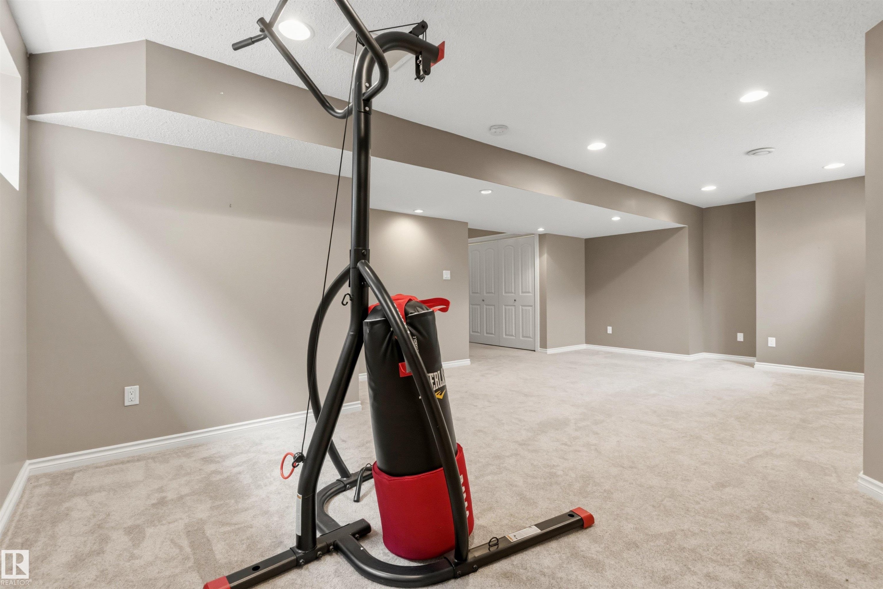 Spacious finished basement featuring recessed lighting, light-toned carpeting, neutral wall paint, and white trim molding - 3214 22A Avenue Nw, Edmonton, AB - Indoor