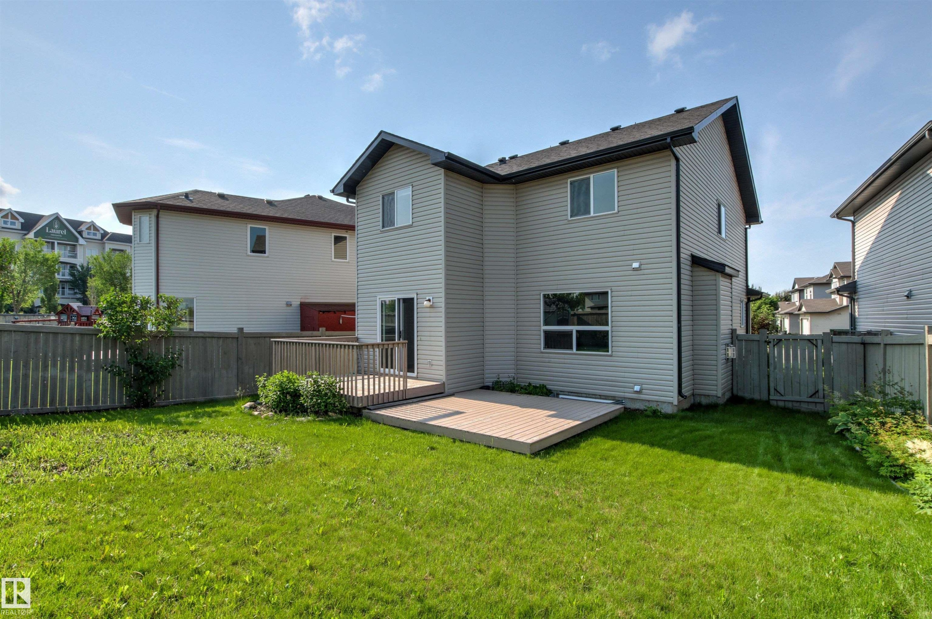 Expansive backyard with a green lawn and a composite deck - 3214 22A Avenue Nw, Edmonton, AB - Outdoor With Exterior