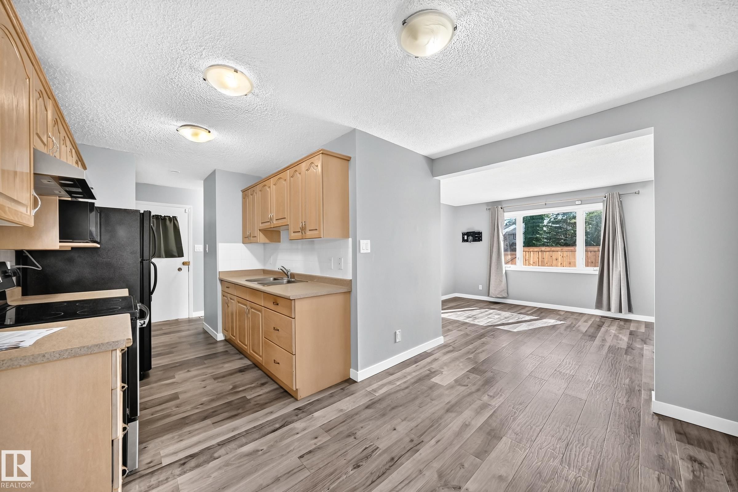 261 Callingwood Two Nw, Edmonton, AB - Indoor Photo Showing Kitchen With Double Sink