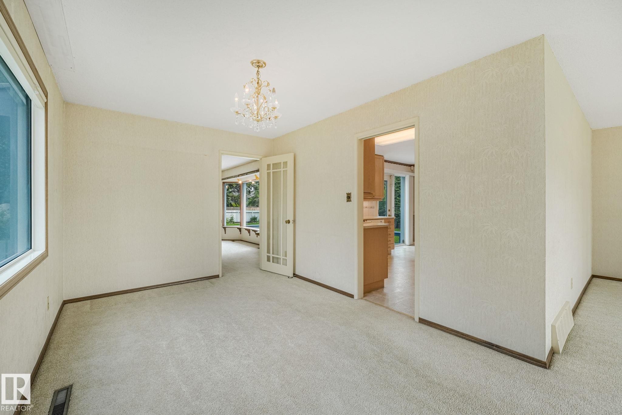 Spacious interior room with light-toned carpeting and textured walls - 13320 79 Avenue Nw, Edmonton, AB - Indoor Photo Showing Other Room