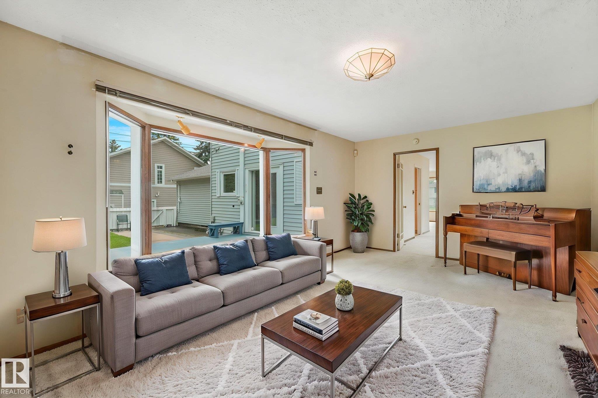 Inviting living space featuring a large bay window, neutral wall tones, and overhead flush-mount lighting - 13320 79 Avenue Nw, Edmonton, AB - Indoor Photo Showing Living Room